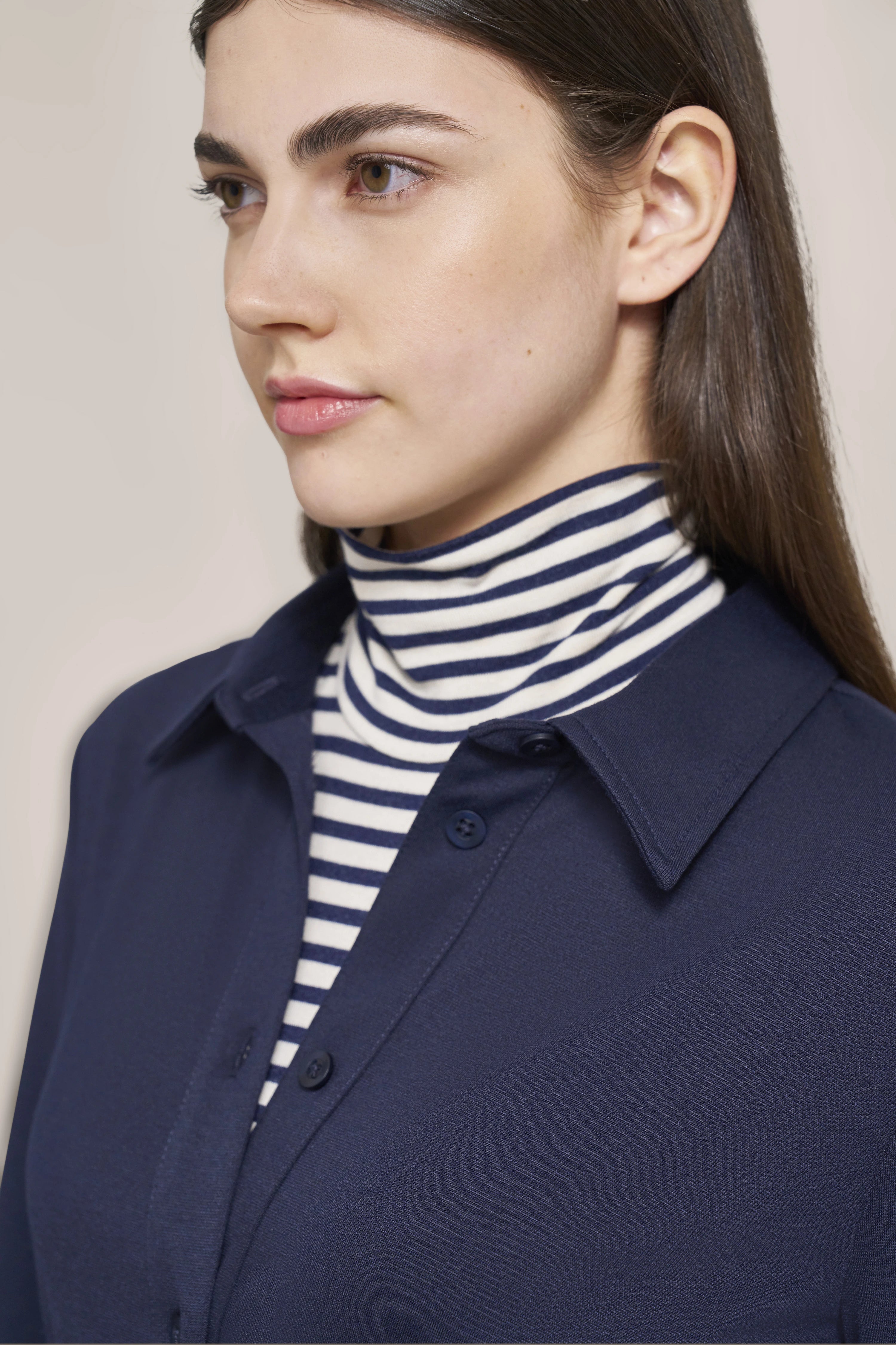 Bust portrait with blue shirt and striped turtleneck, bugatti style.