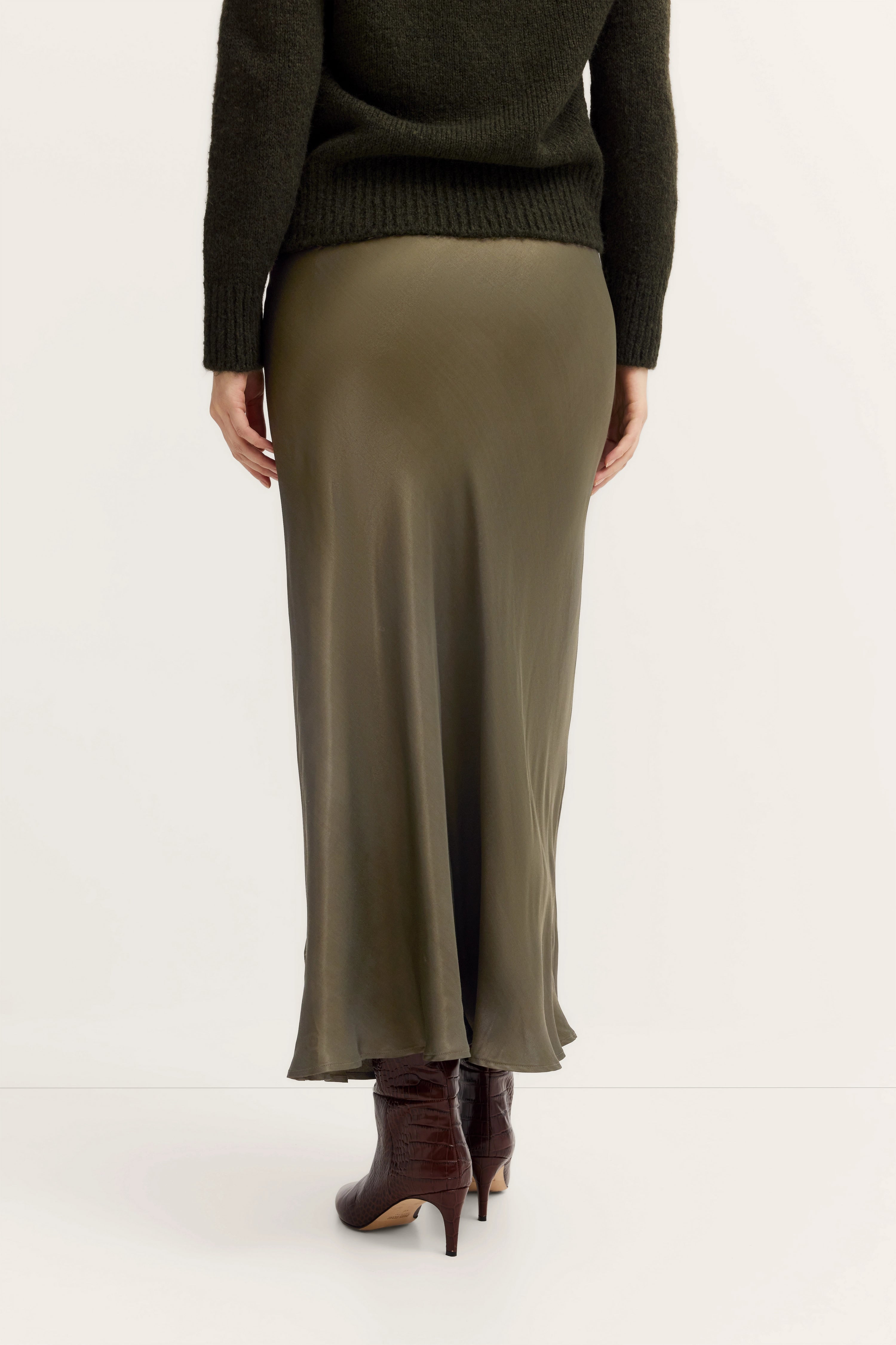 Groene rok met zwarte trui en bruine enkellaarzen van bugatti.