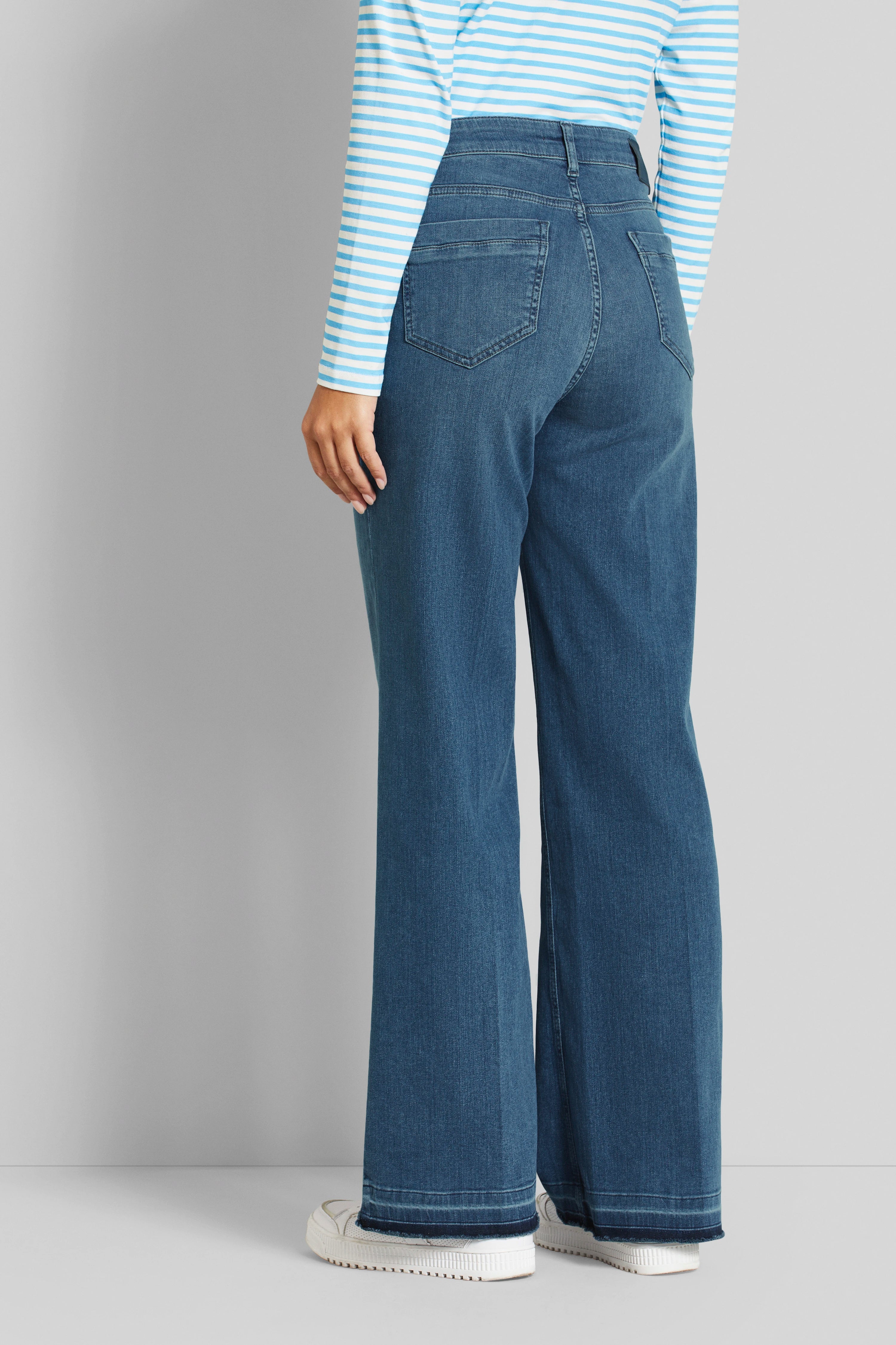 Blau-weiß gestreiftes Longsleeve und blaue Jeans, legeres Modelbild, Rückansicht.