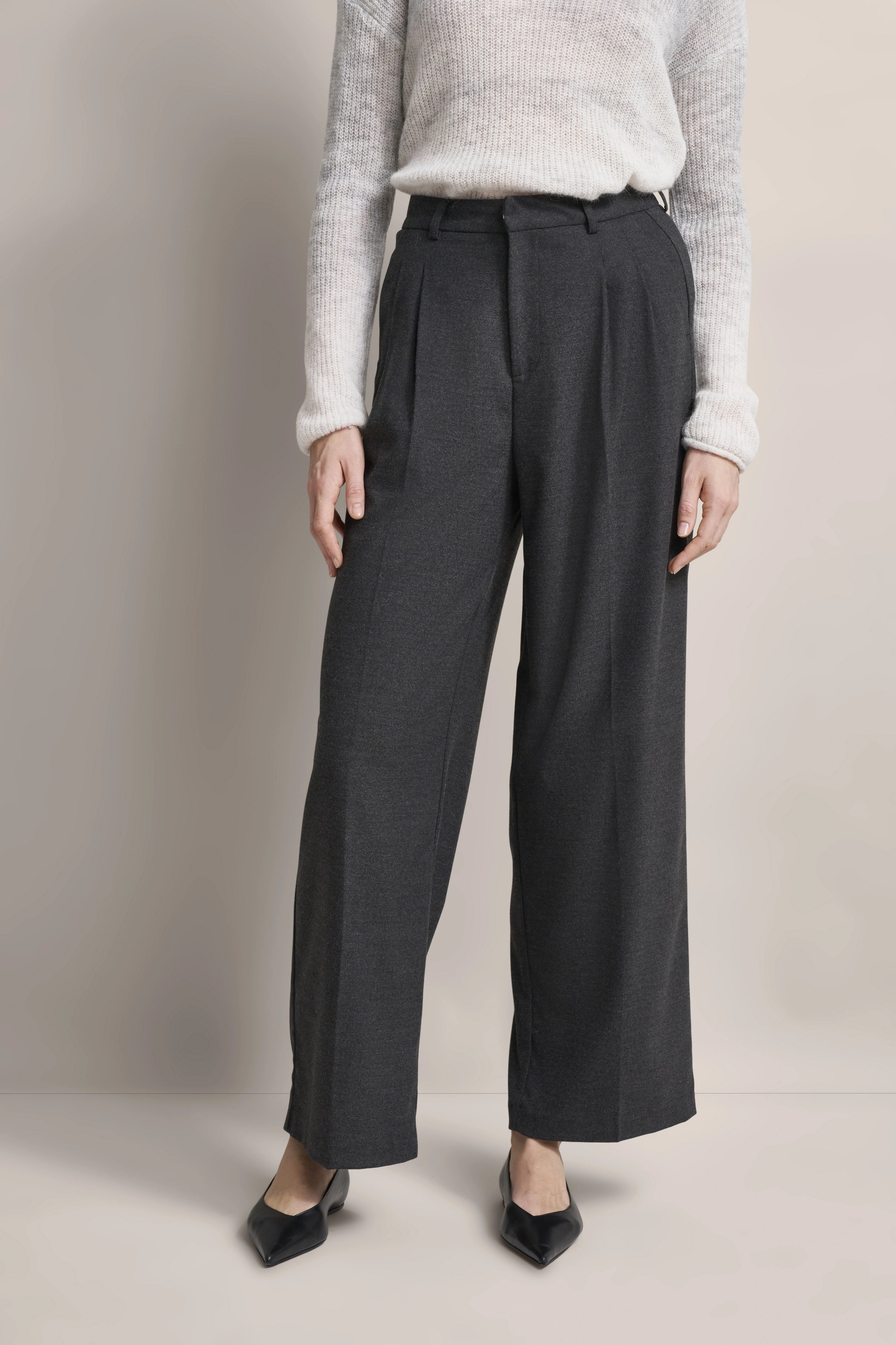 Gray bugatti pants with white sweater, casually styled, perfect blend of elegance and comfort.