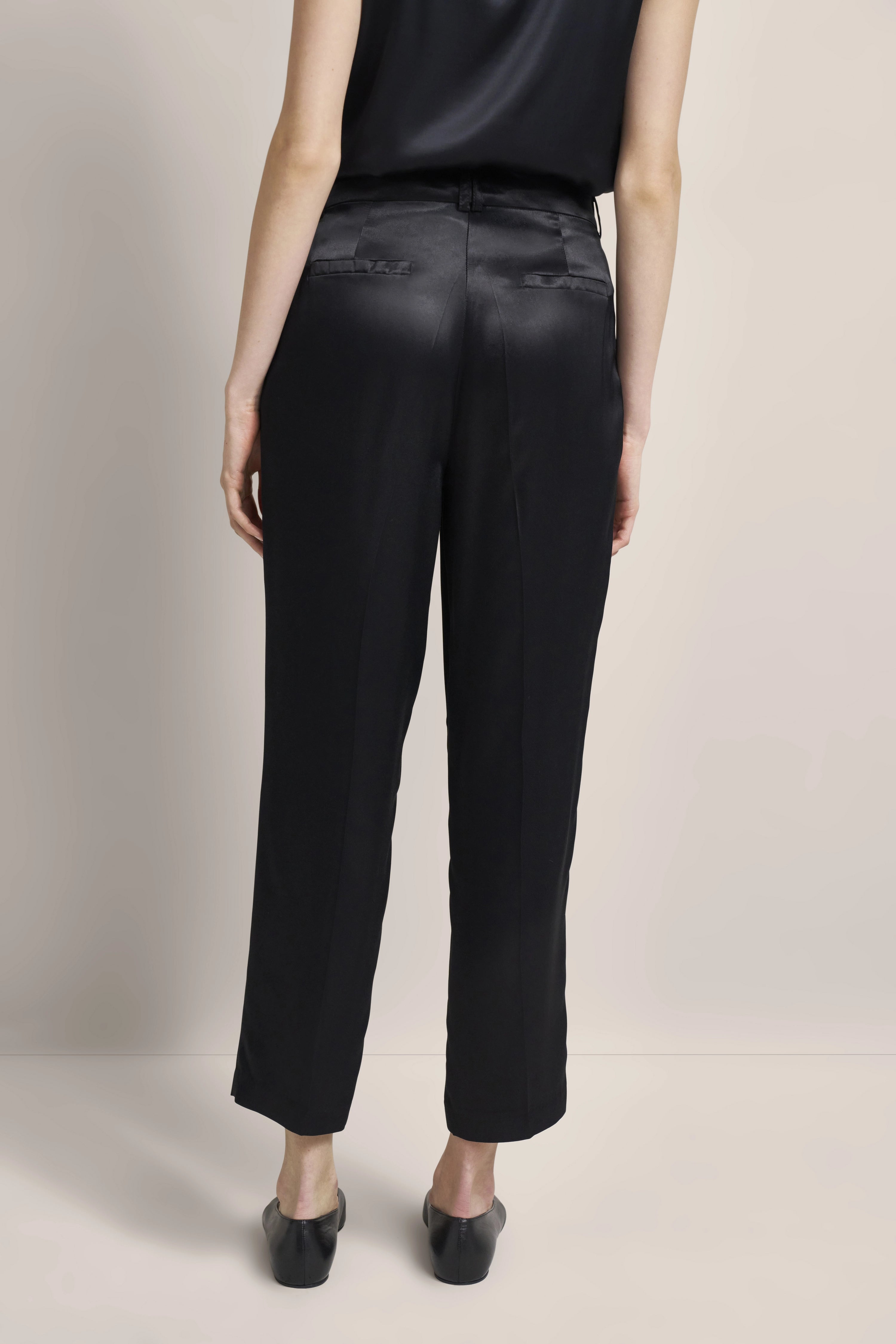 Black satin trousers by bugatti, model rear view, relaxed fit, elegant design.