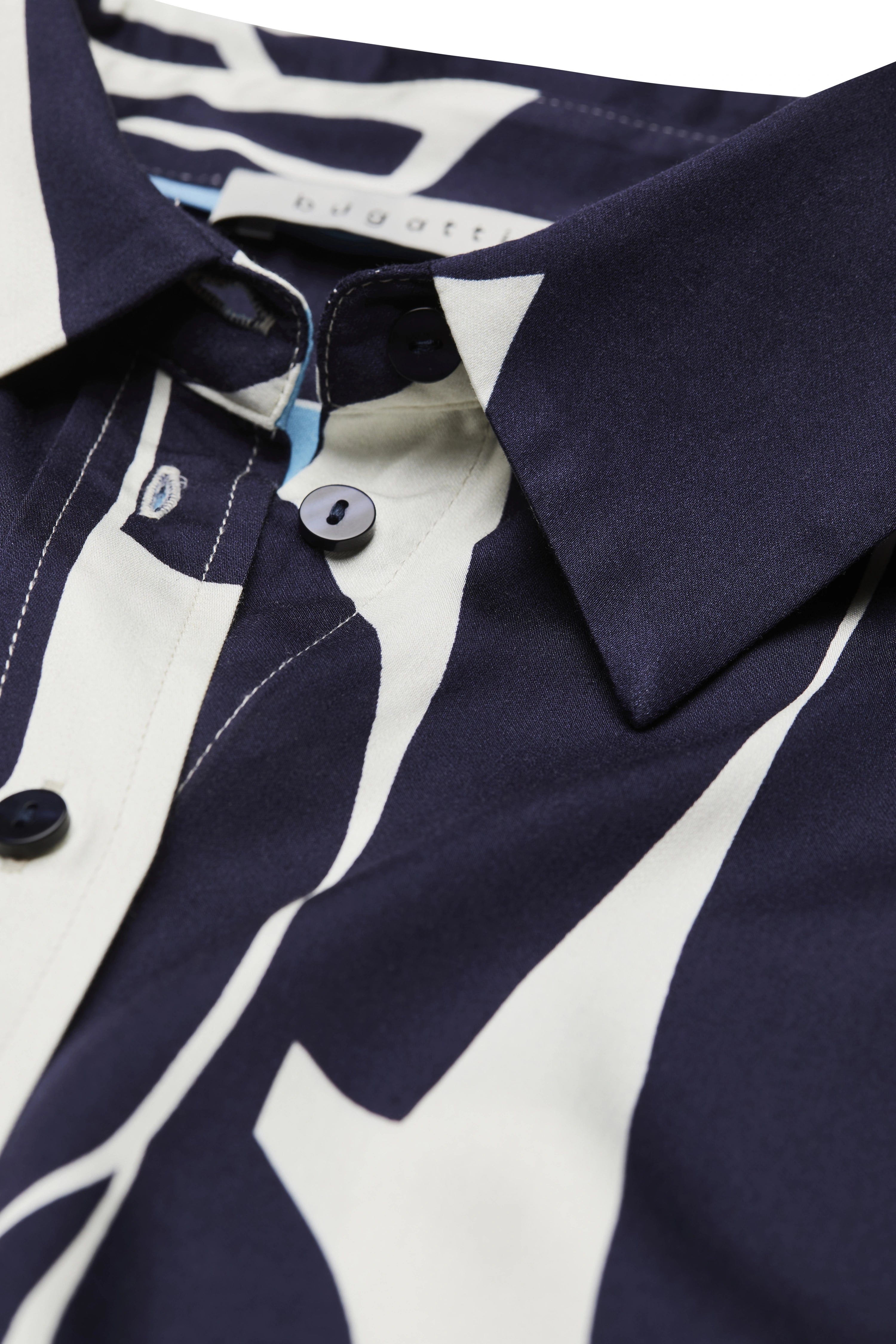 Blue-white bugatti shirt with graphic pattern, close-up, elegant details.