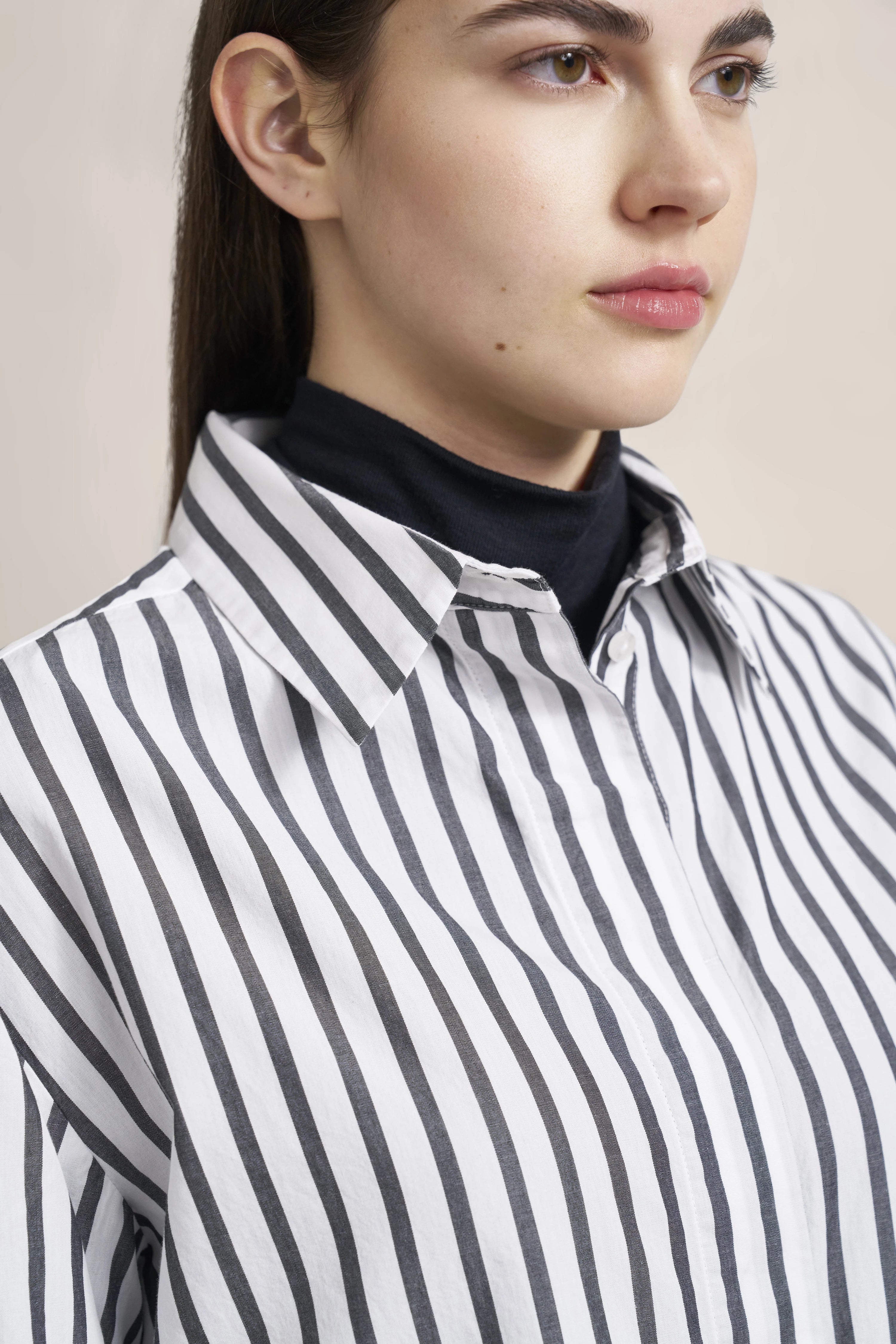 Close-up of a black and white striped shirt, bust view, classic elegance.