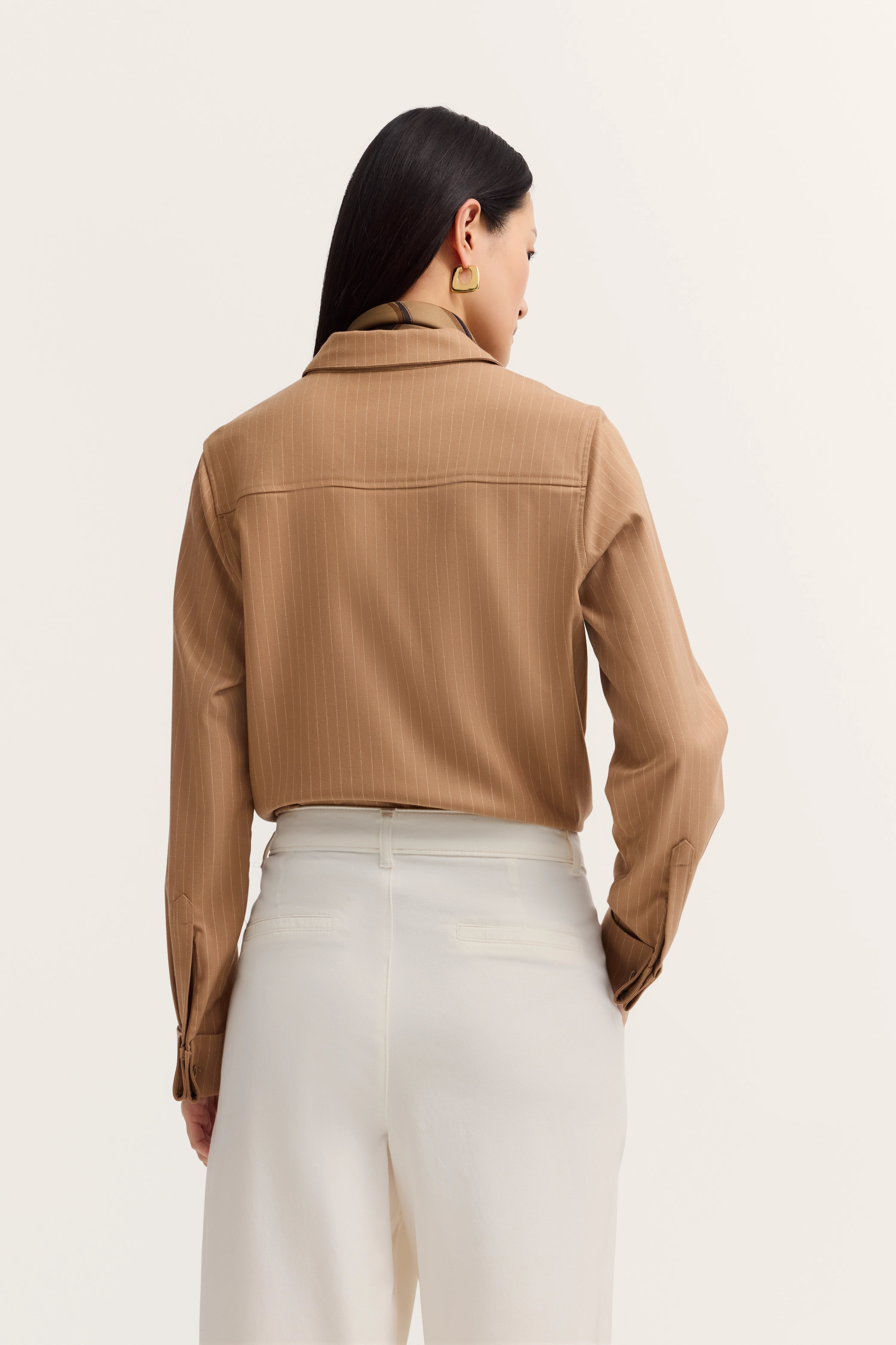Braunes Streifenhemd und weiße Hose, Model von hinten, klassischer Look.