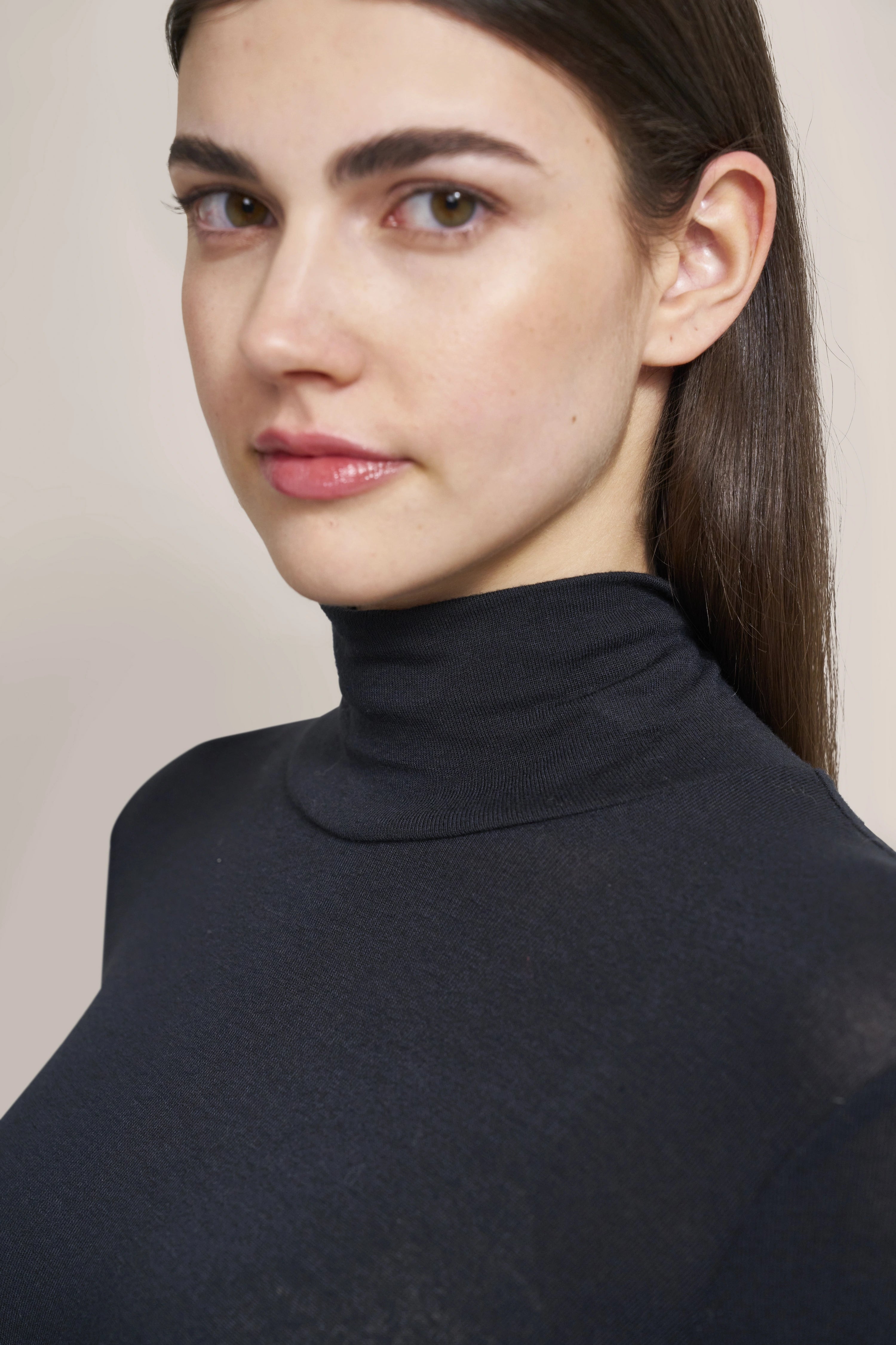Close-up of black bugatti turtleneck sweater, simple design, timeless elegance.