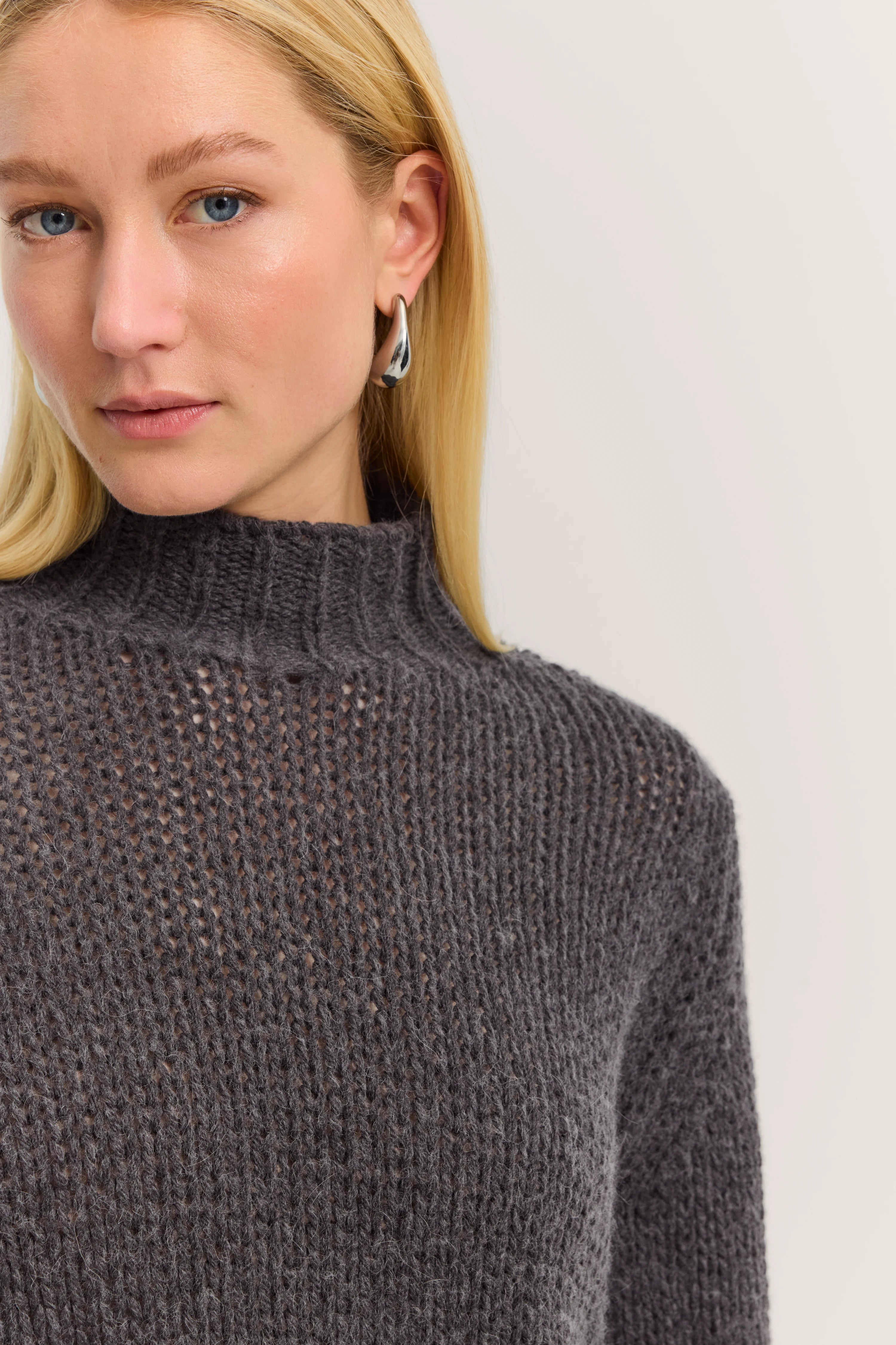 Dark gray bugatti knit sweater, high neck, chunky knit pattern, bust view.