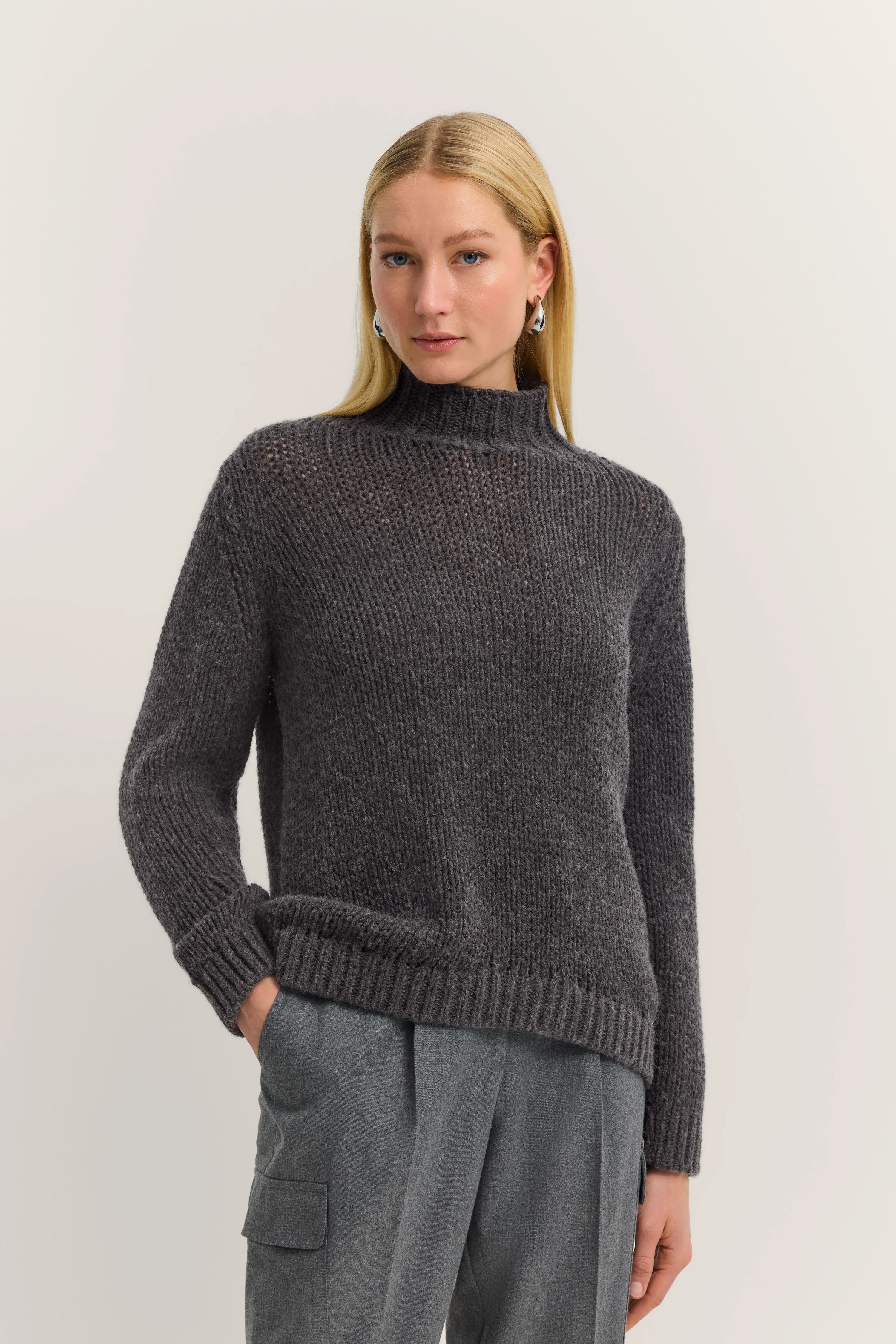 Gray knit sweater with stand-up collar, gray pants, by bugatti.