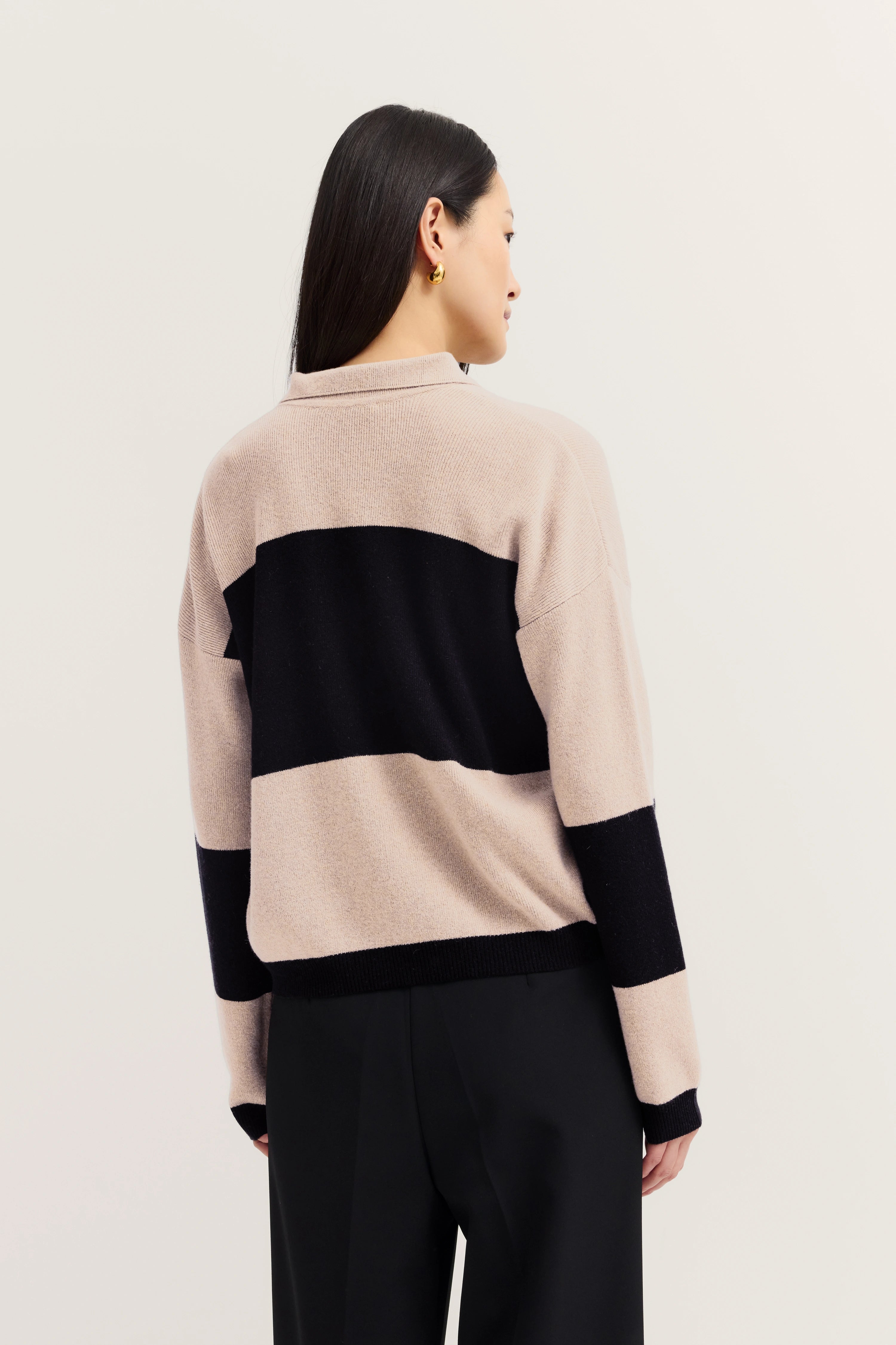 Beige and black striped sweater by bugatti, model in relaxed pose from behind.