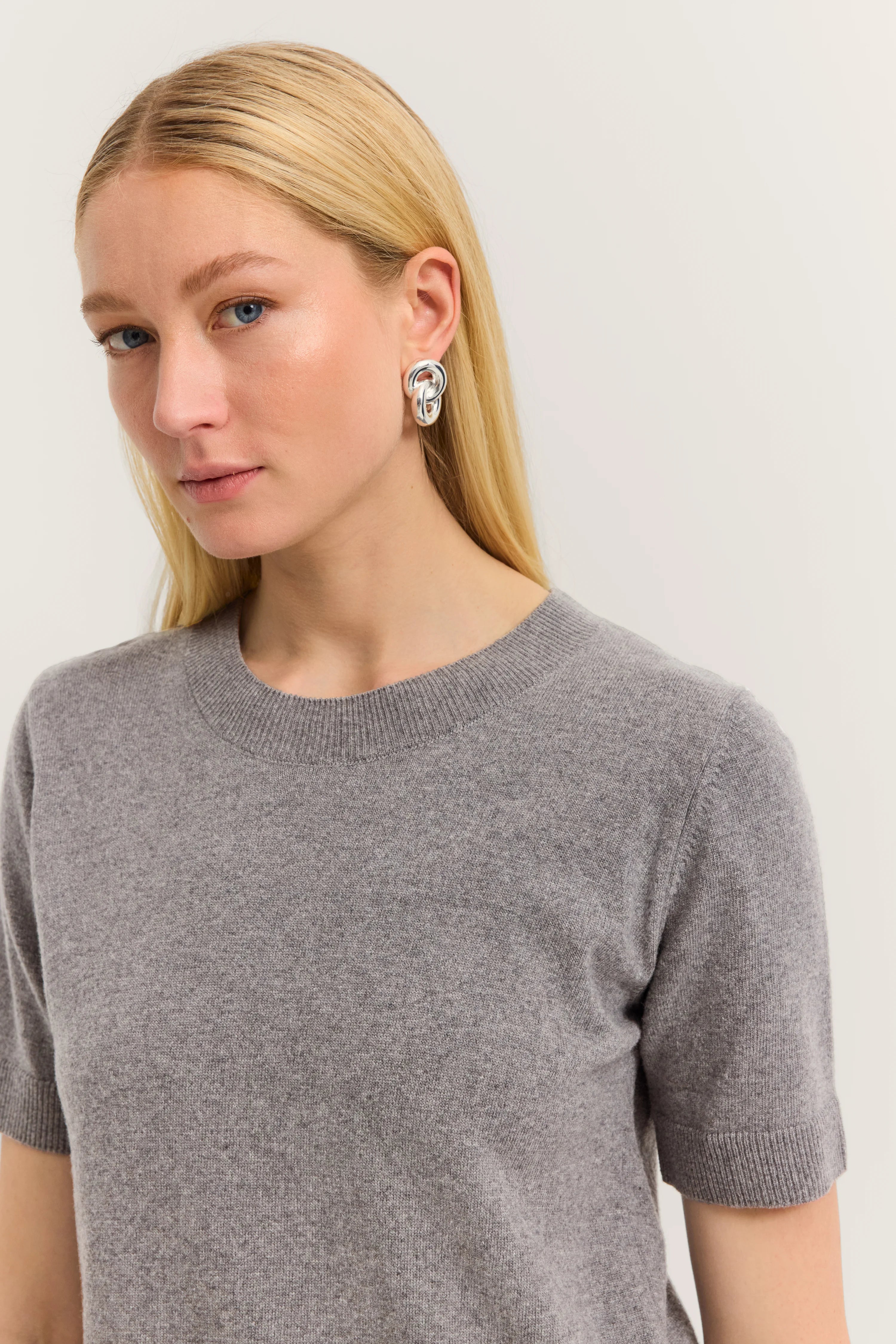 Gray short-sleeve pullover on model, embodying bugatti's elegance and simplicity.