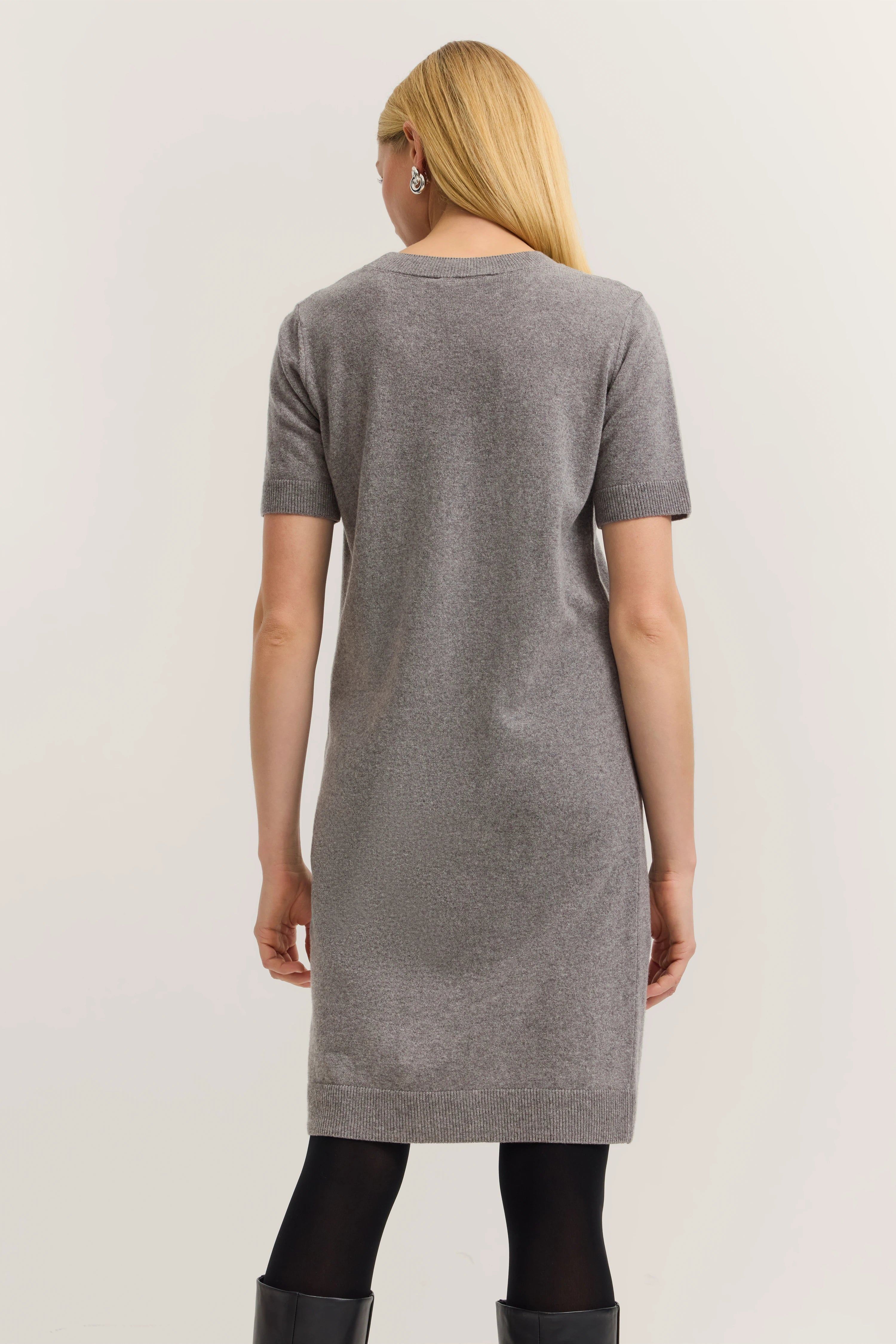 Gray knit dress by bugatti, model from behind in relaxed pose, timeless elegance.