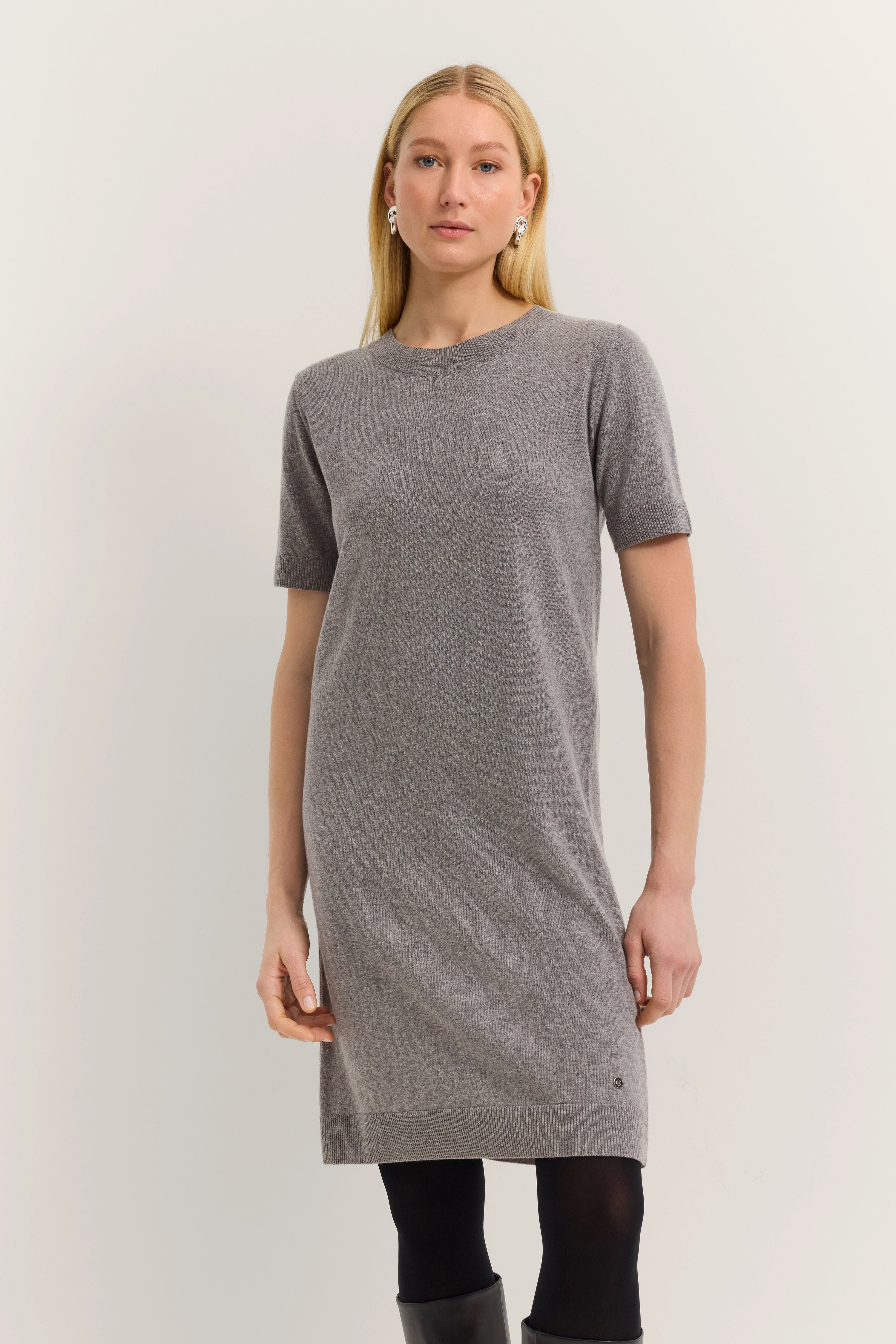 Gray bugatti knit dress on model, casually posing, elegant look.