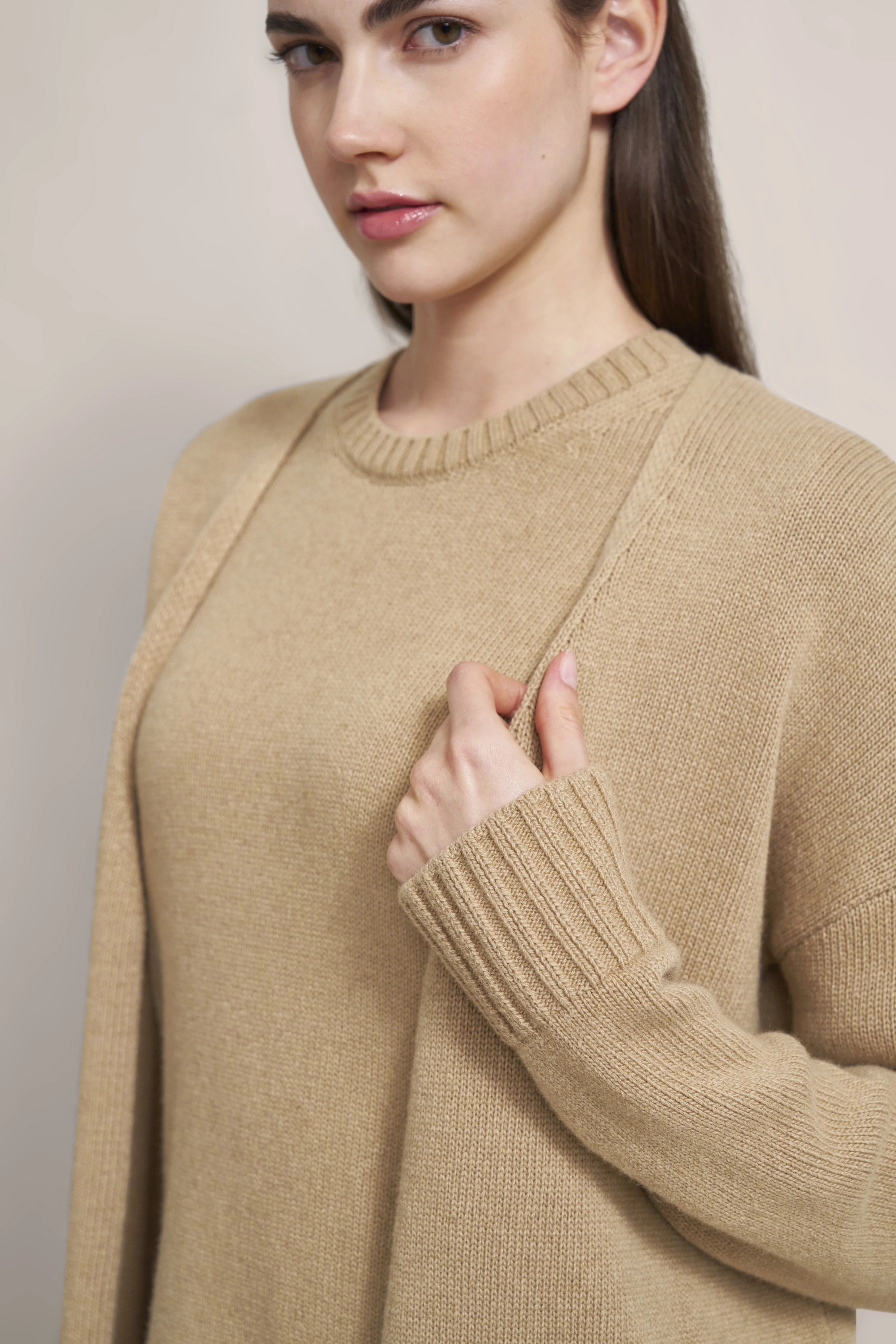Beige bugatti sweater, model close-up, right hand on collar, relaxed pose.