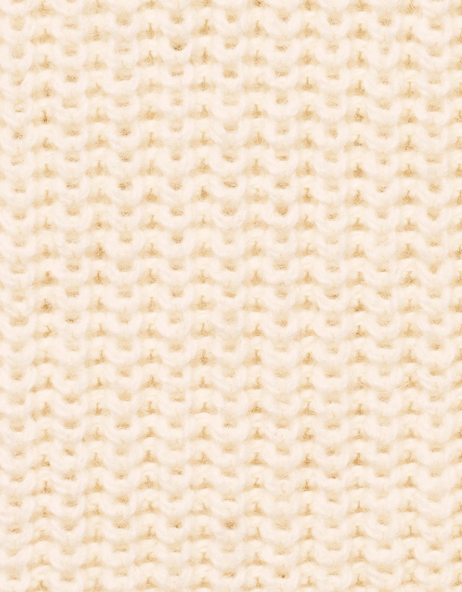 Strickmuster in Creme, Detailaufnahme.
