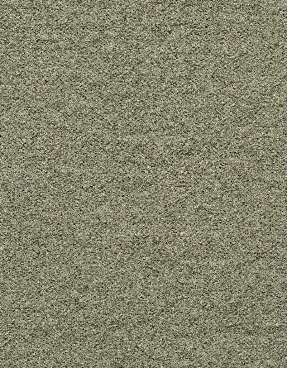 Grüner Strickstoff mit texturierter Oberfläche, Nahaufnahme.