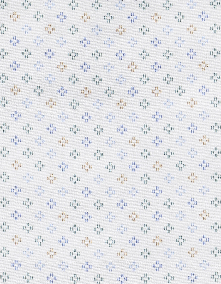 Weißer Stoff mit kleinen, blauen, grünen und braunen geometrischen Mustern.
