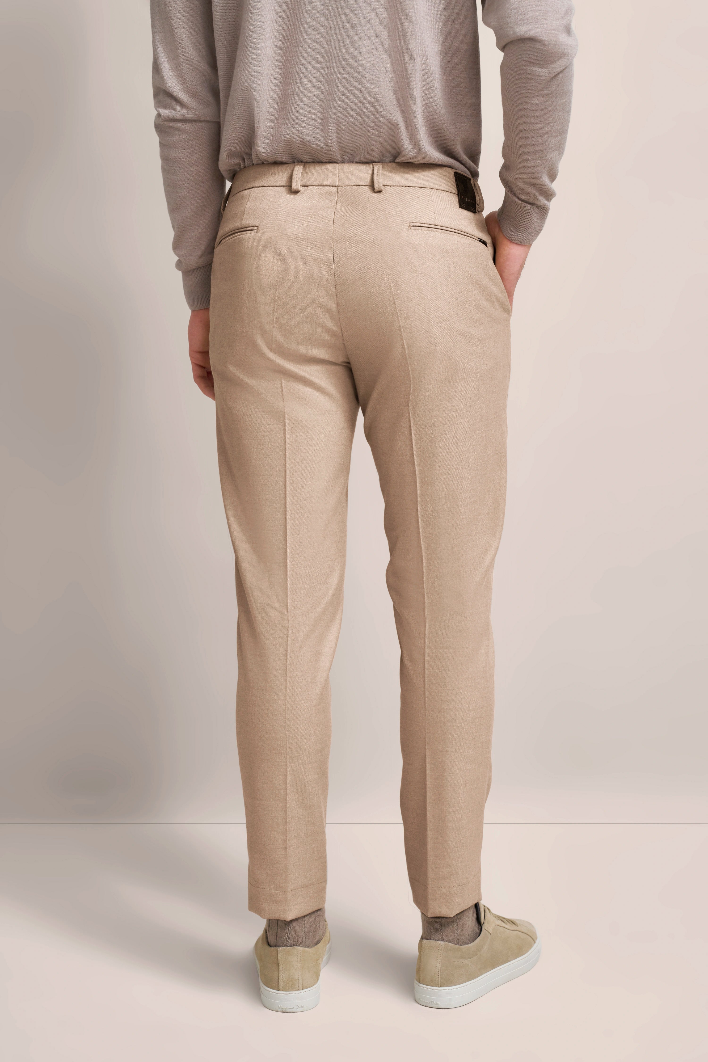 Beige bugatti trousers in casual style, back view, paired with grey sweater and beige sneakers.
