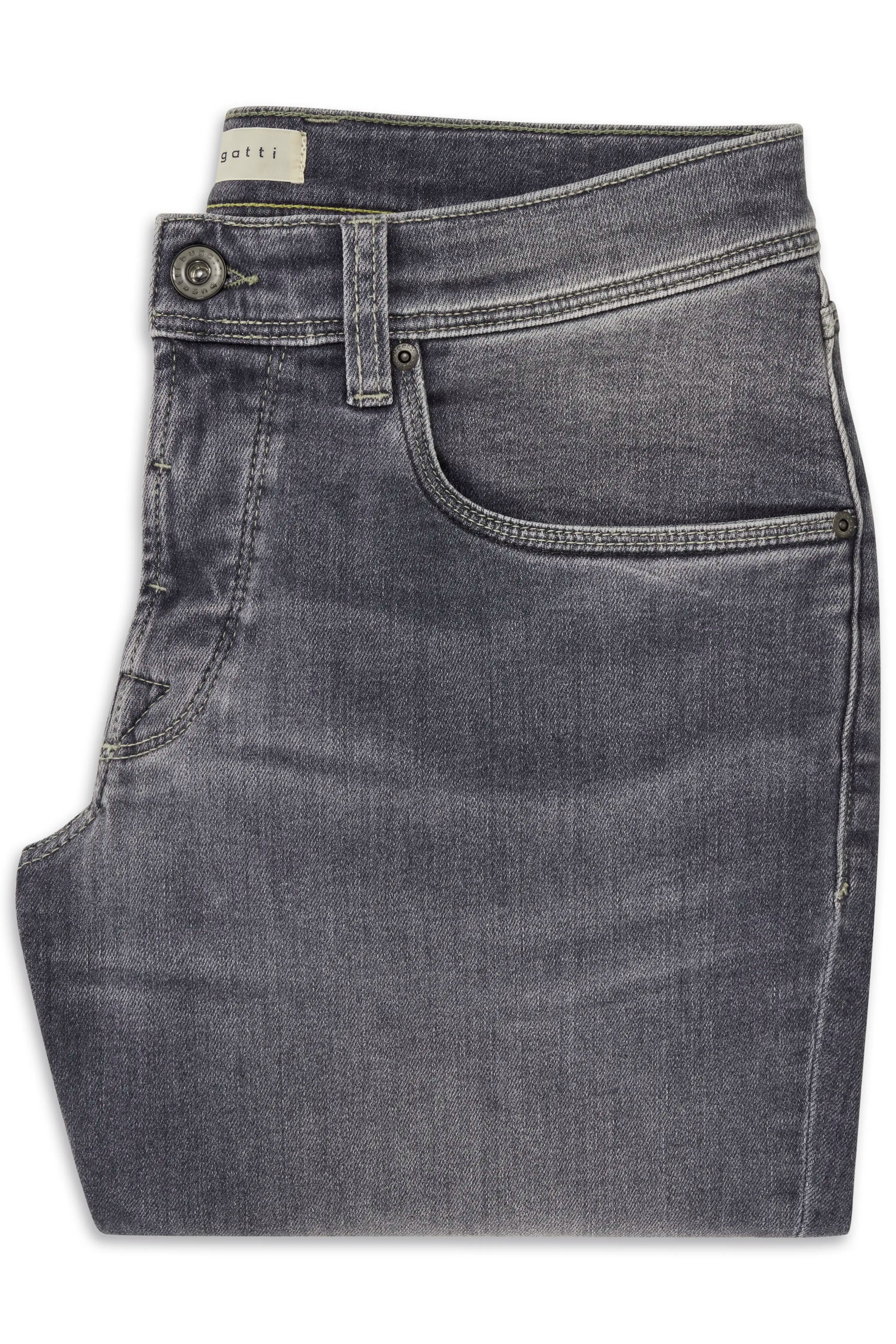Weißes Hemd, blaue Jeans, beiges Schuhwerk, Modell stehend, Hände in Hosentaschen.