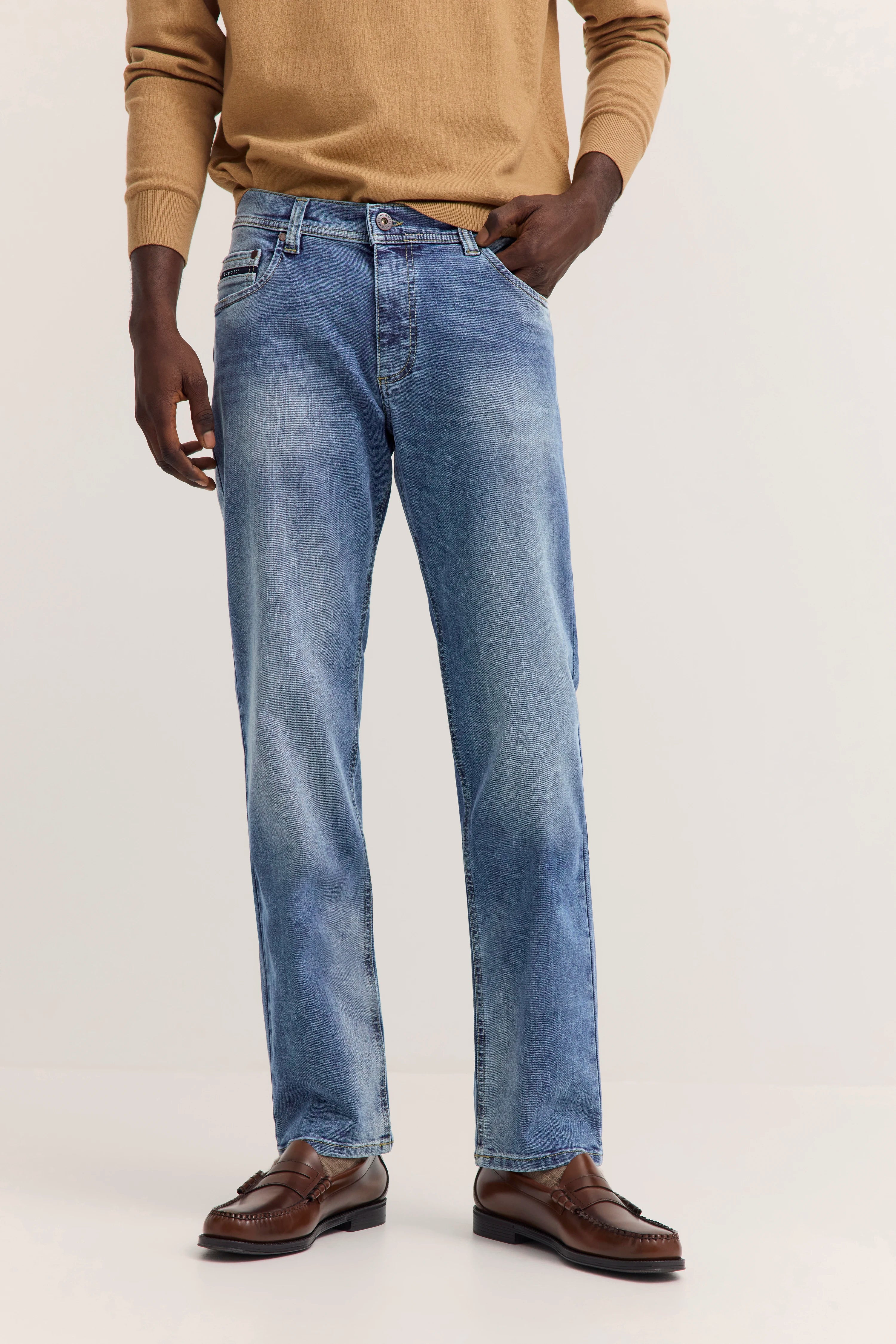 Legeres Modelbild: blaue Jeans, brauner Pullover, braune Loafer
