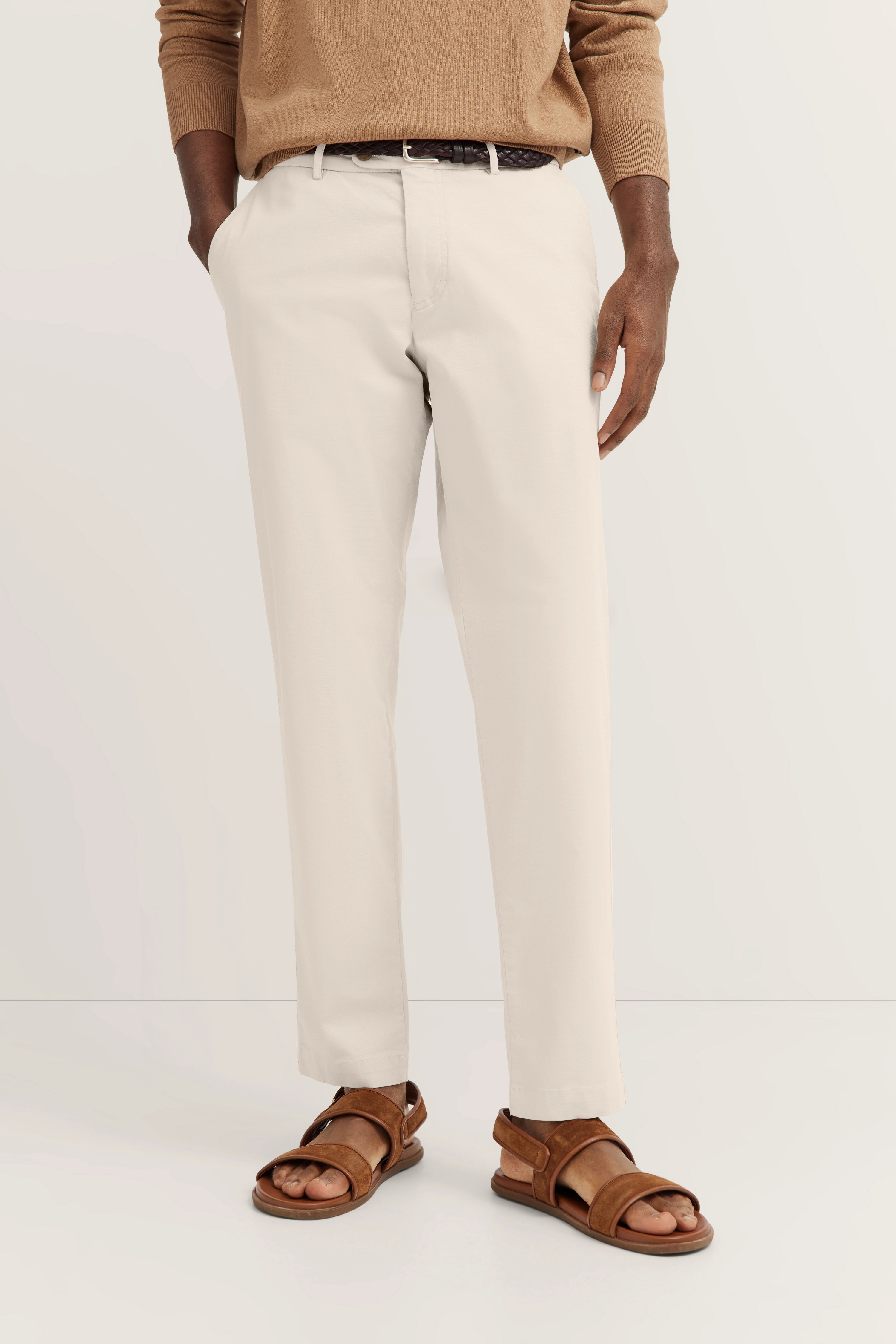Beige chino met bruine riem en sandalen, casual modelpose, bugatti stijl en elegantie.