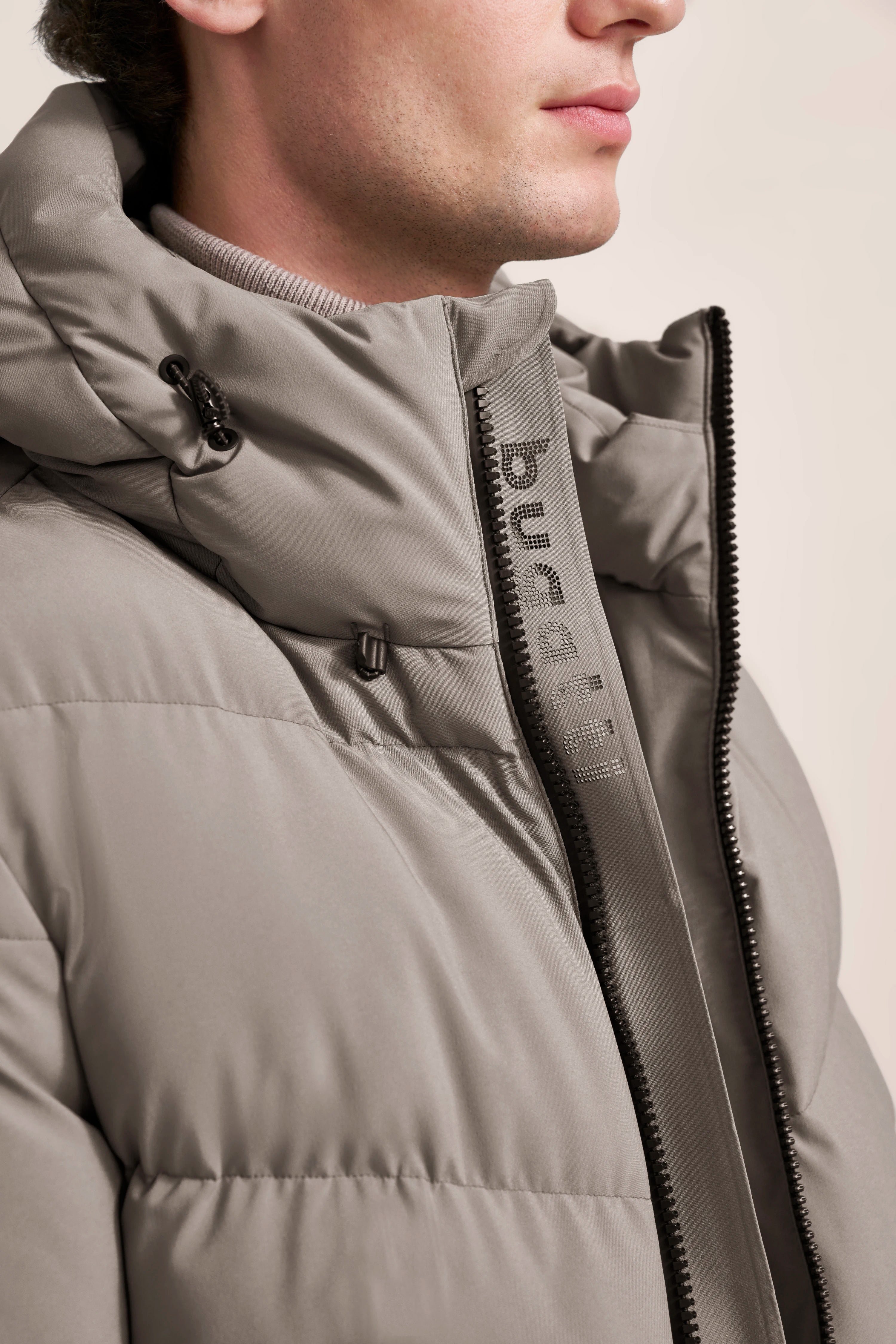 Graue bugatti Steppjacke im Büstenbild mit Reißverschluss und Kapuze, zeitlos elegant und stilvoll.