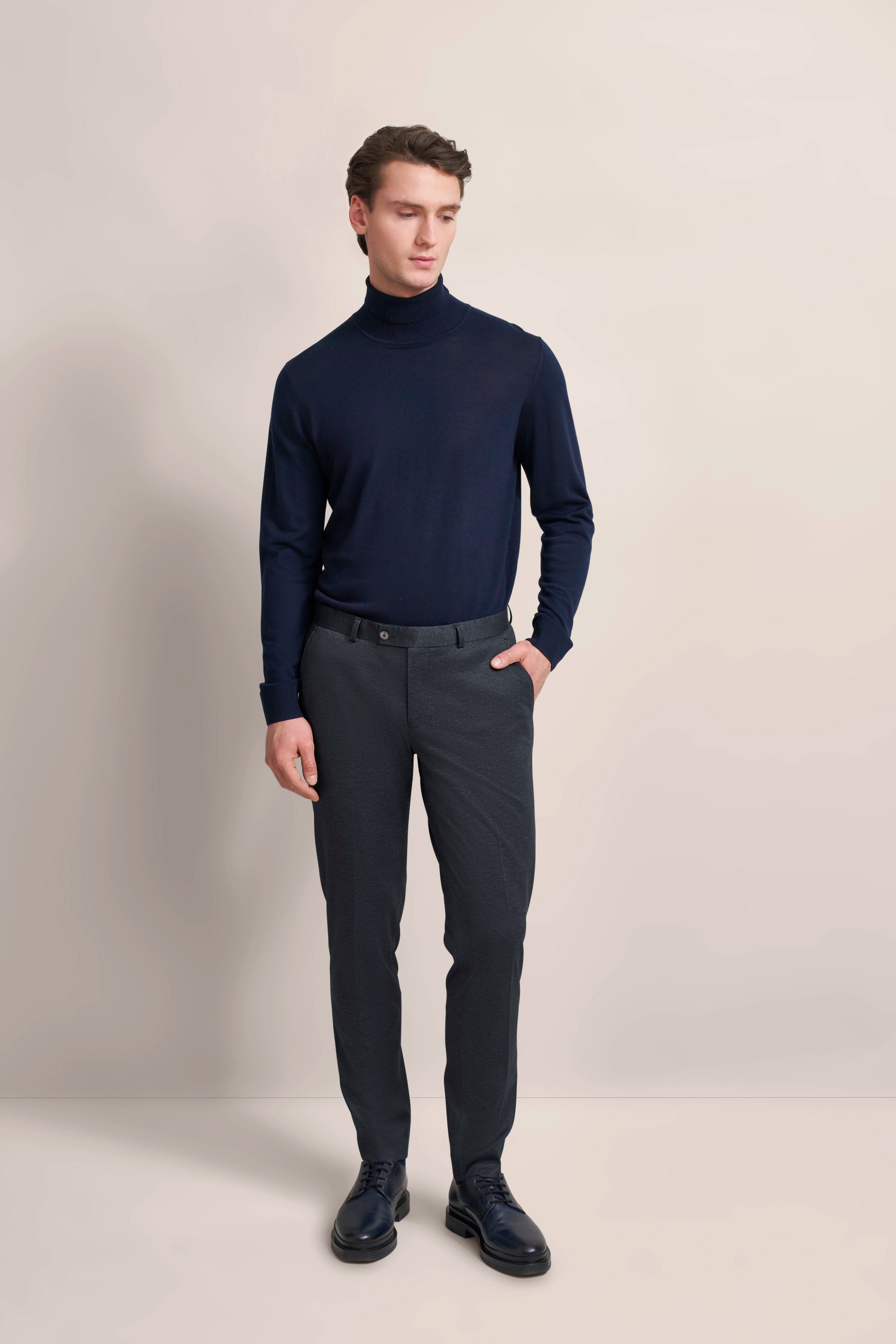 Elegant dark blue bugatti trousers, modeled from the back, showcasing classic fit.