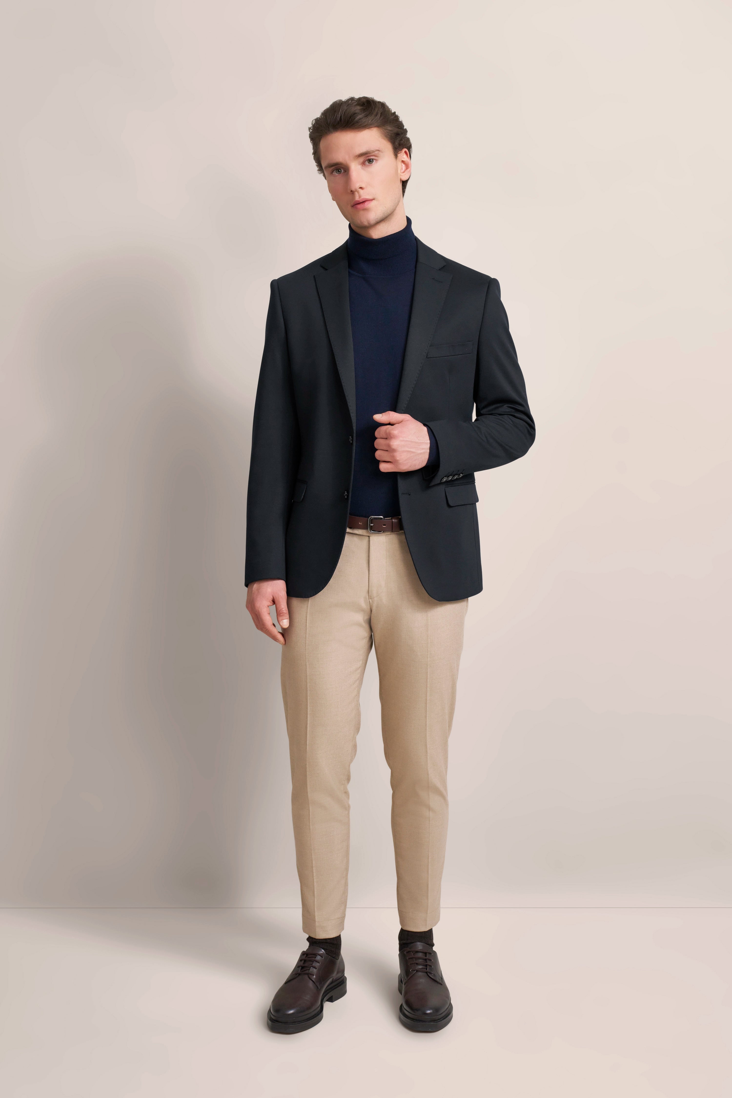 bugatti dark blue blazer, model back view, paired with beige trousers.