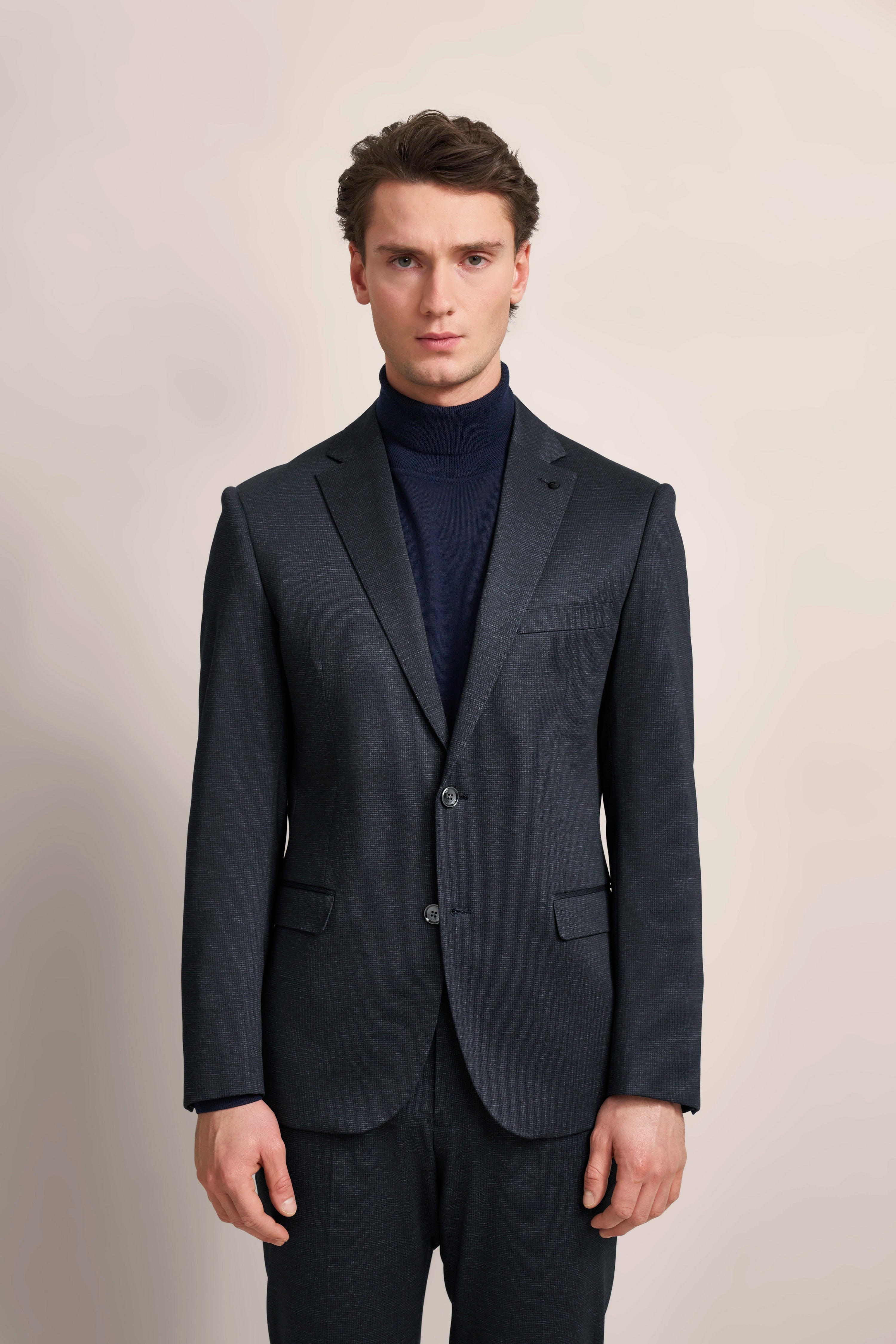 bugatti dark blue suit, model smiling slightly, formal, stylish, elegant, exuding sophistication and timeless beauty.