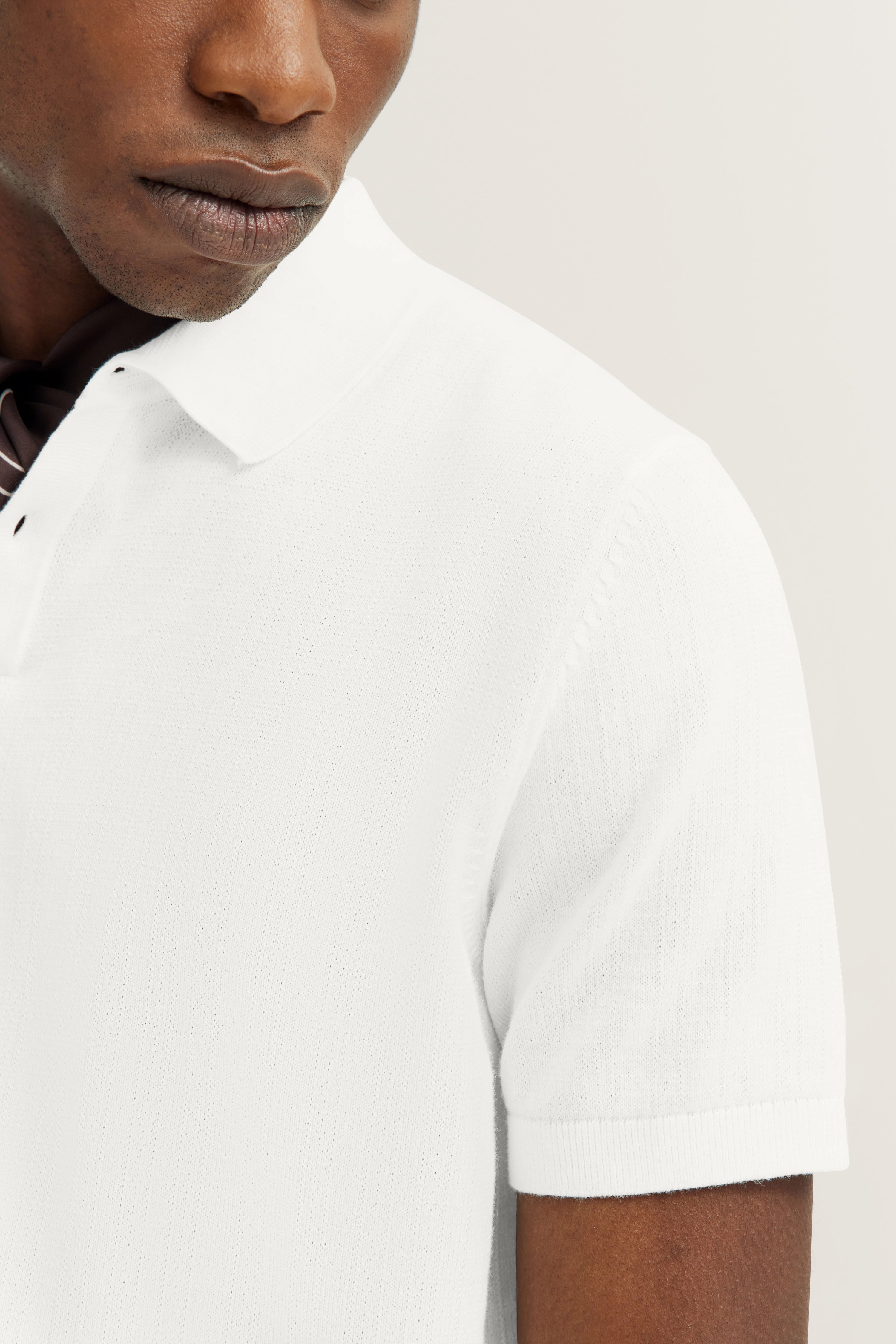 White bugatti short-sleeve polo shirt, classic design, bust view.