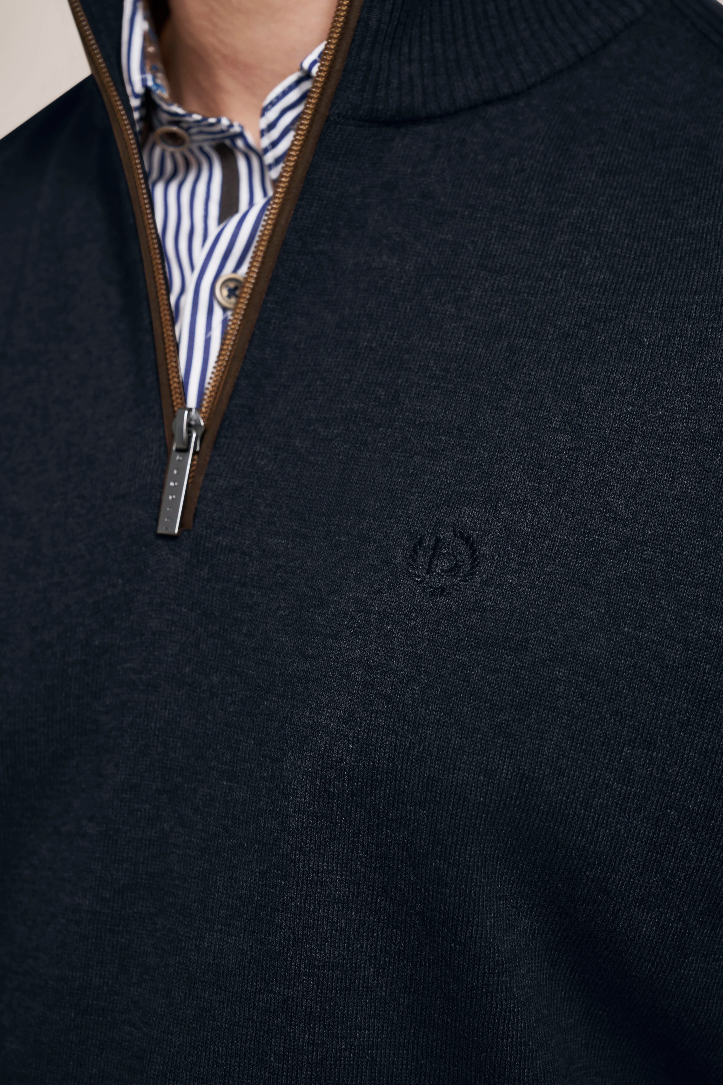Navy bugatti sweater with zipper, striped shirt underneath, bust view.