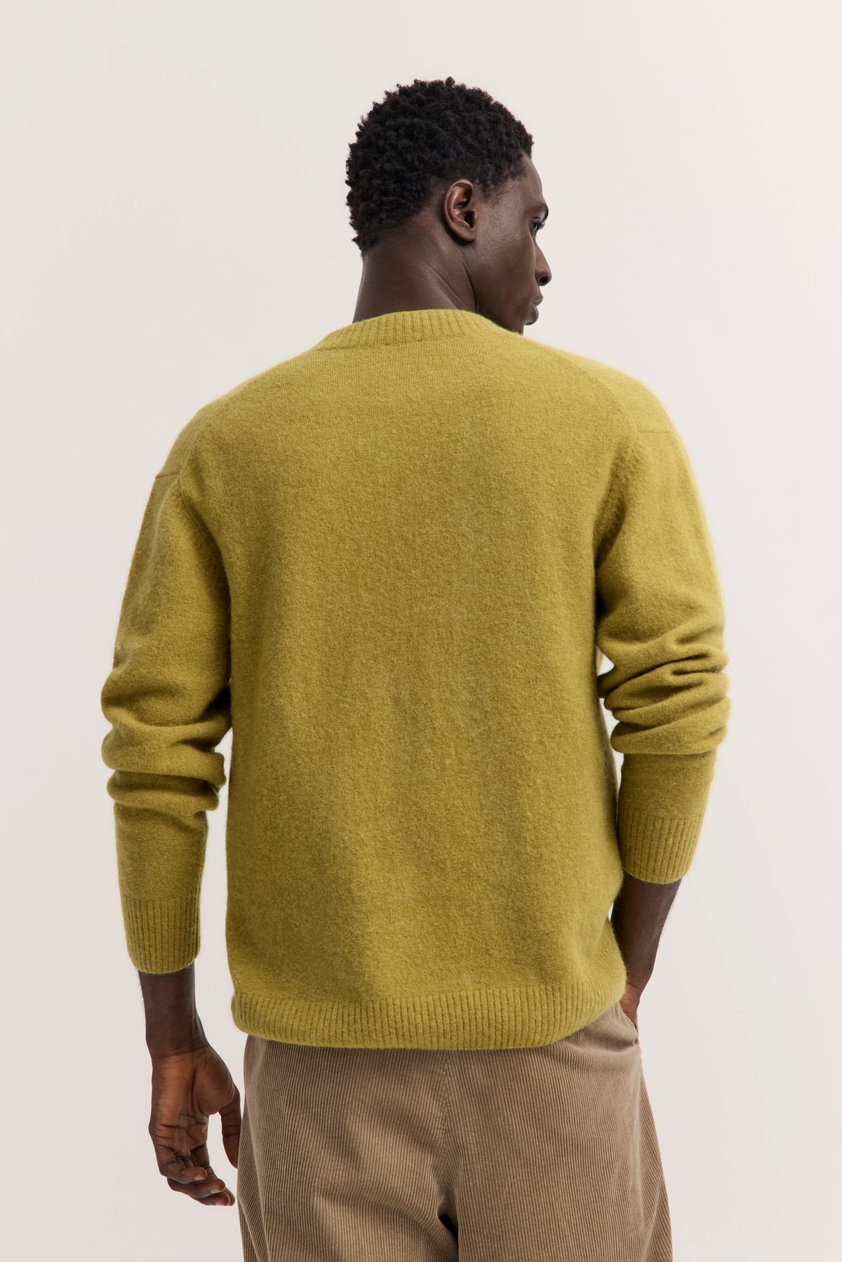 Olivefarbener Pullover von bugatti, Rückansicht, lässig, mit beigen Cordhosen kombiniert.