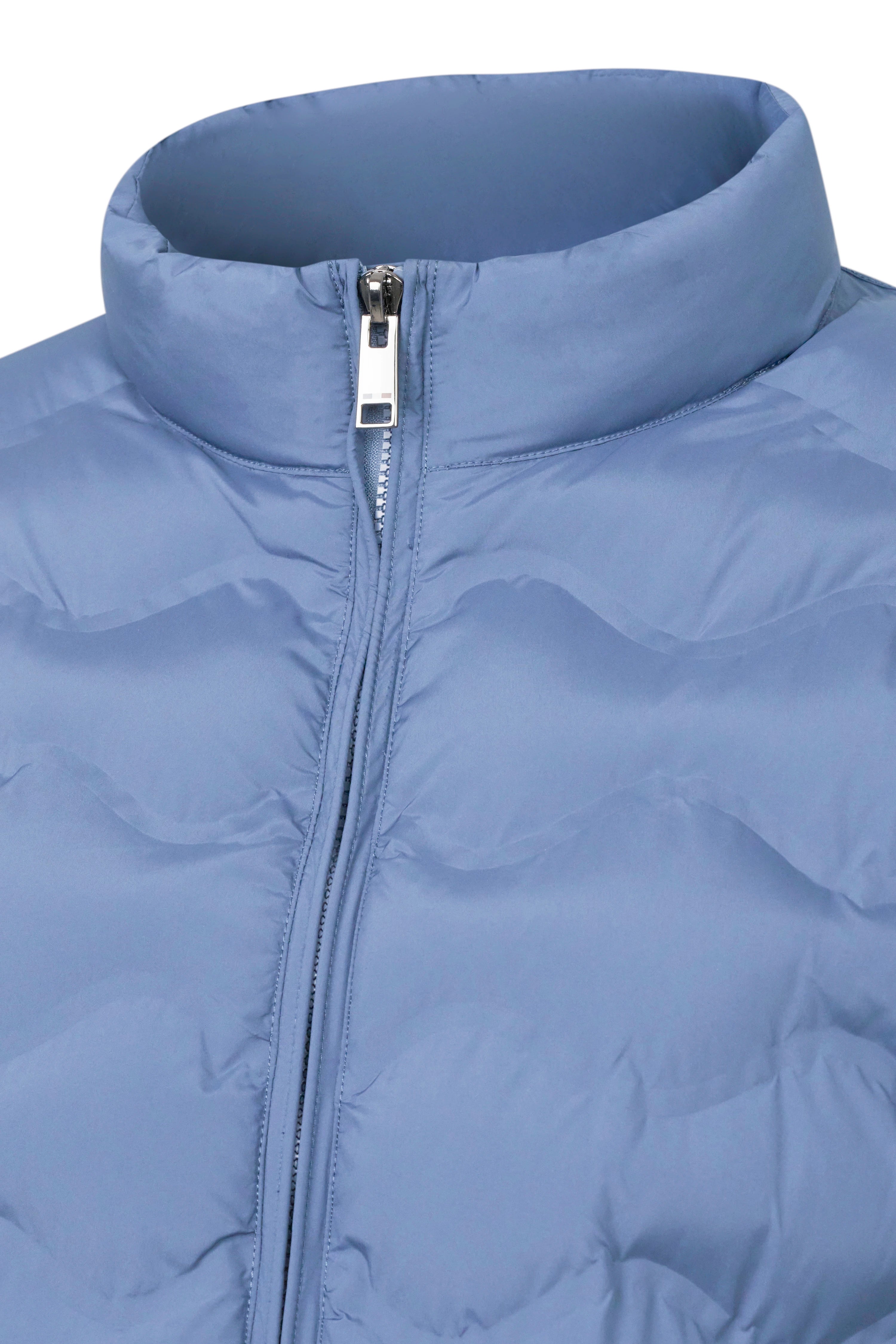 Modelbild mit blauer Steppjacke von bugatti, leicht geöffnet, lässige Pose.