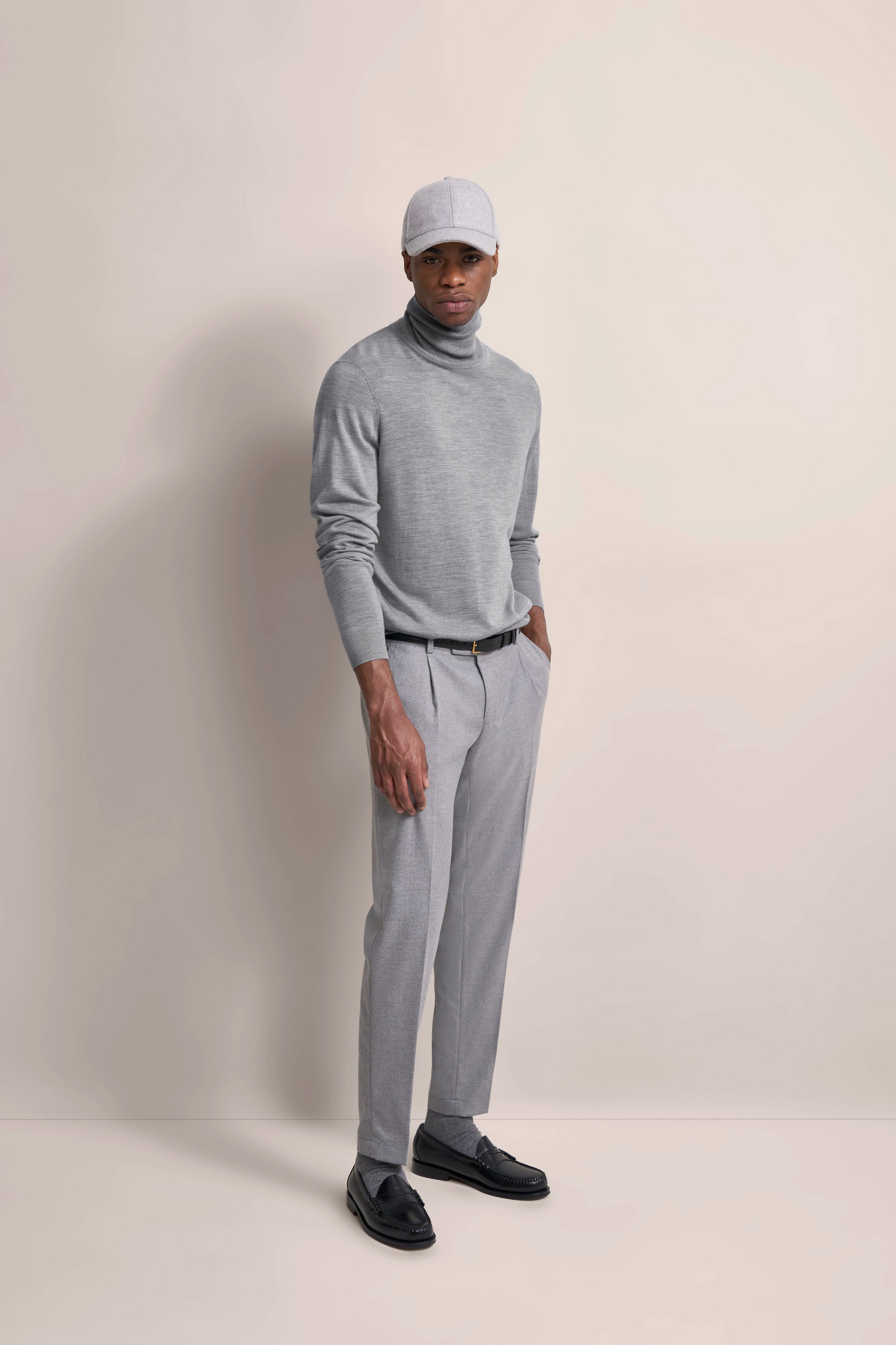 Graues bugatti-Outfit mit Rollkragenpullover, Hose, Kappe