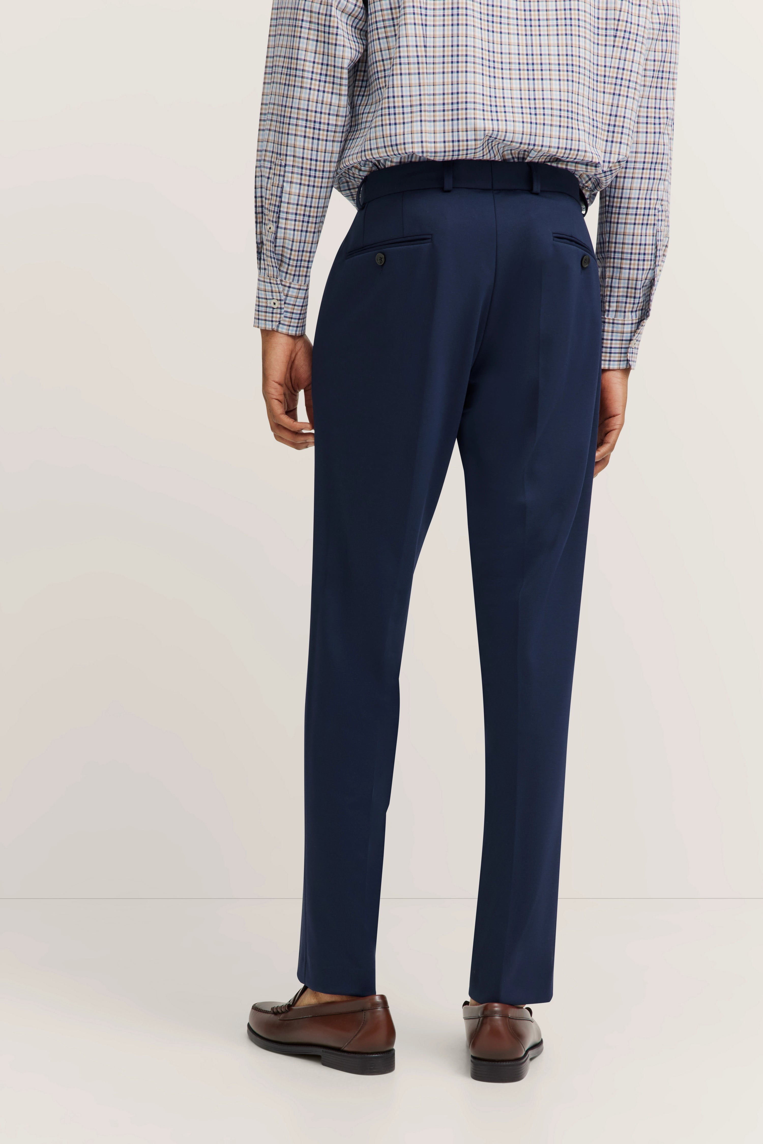 bugatti outfit with checked shirt and blue trousers, casual model image from behind.