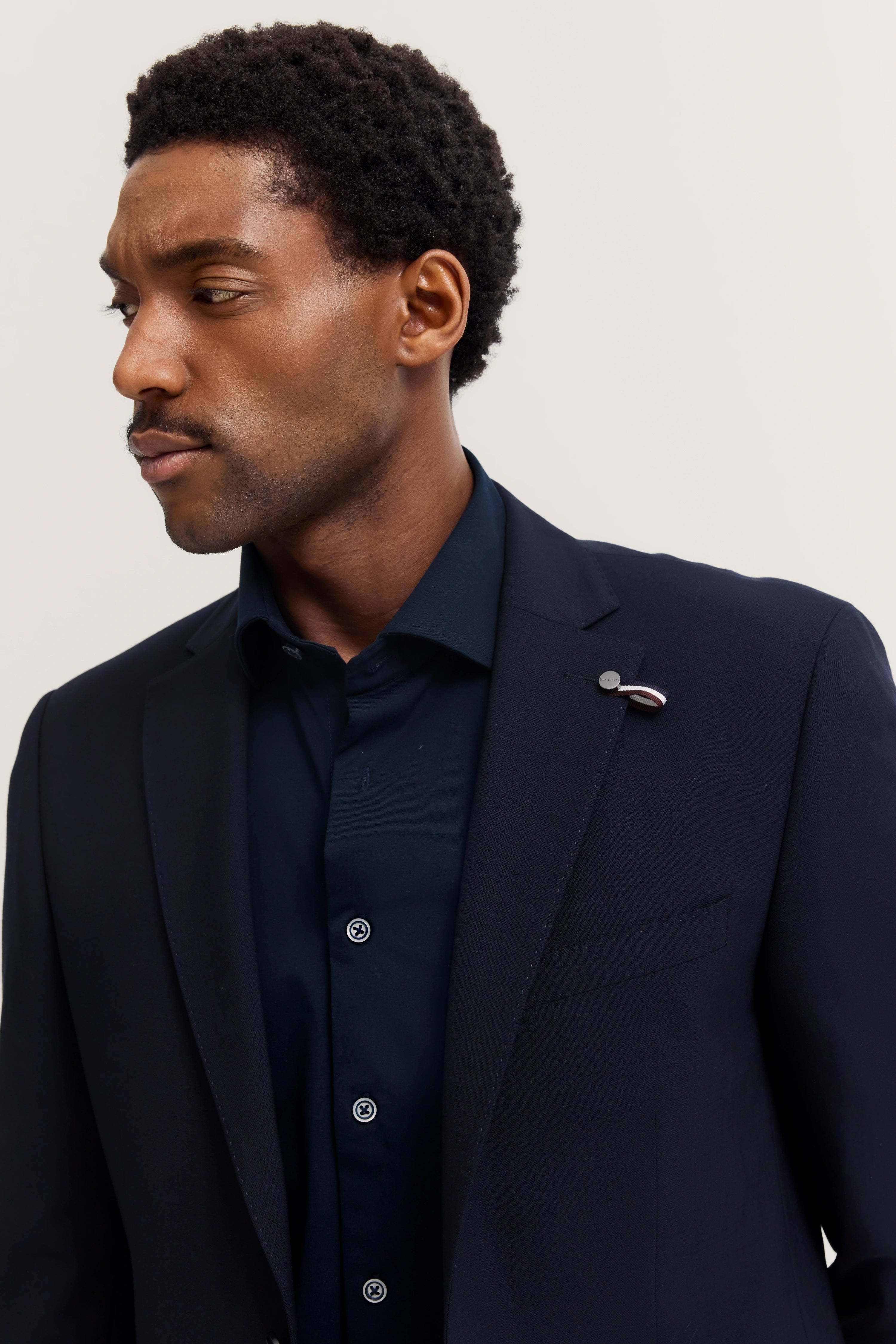 bugatti men's suit in dark blue, bust shot, elegant style, timeless sophistication.