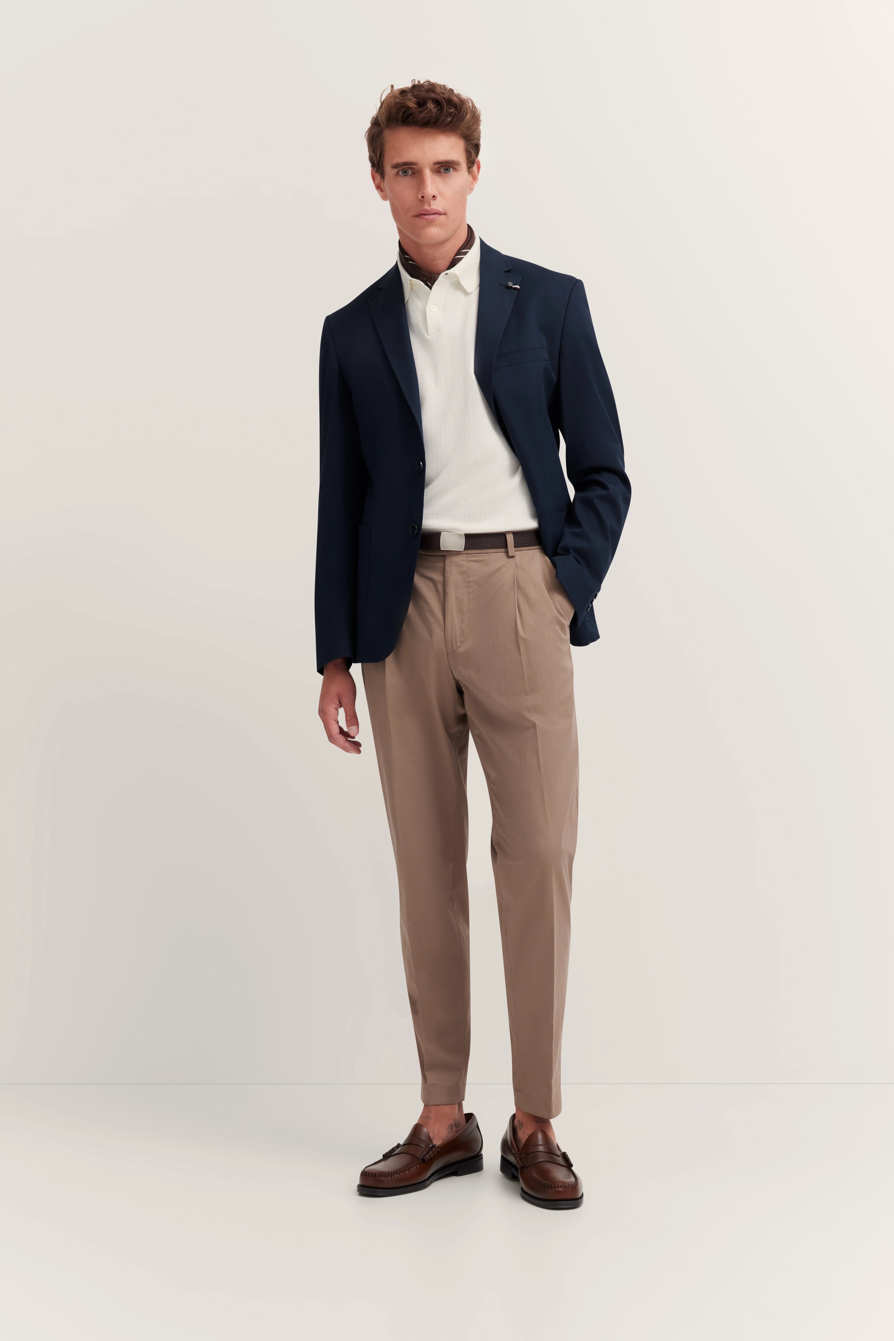 bugatti navy blazer, beige pants, model back view, timeless elegance and Italian-inspired style.