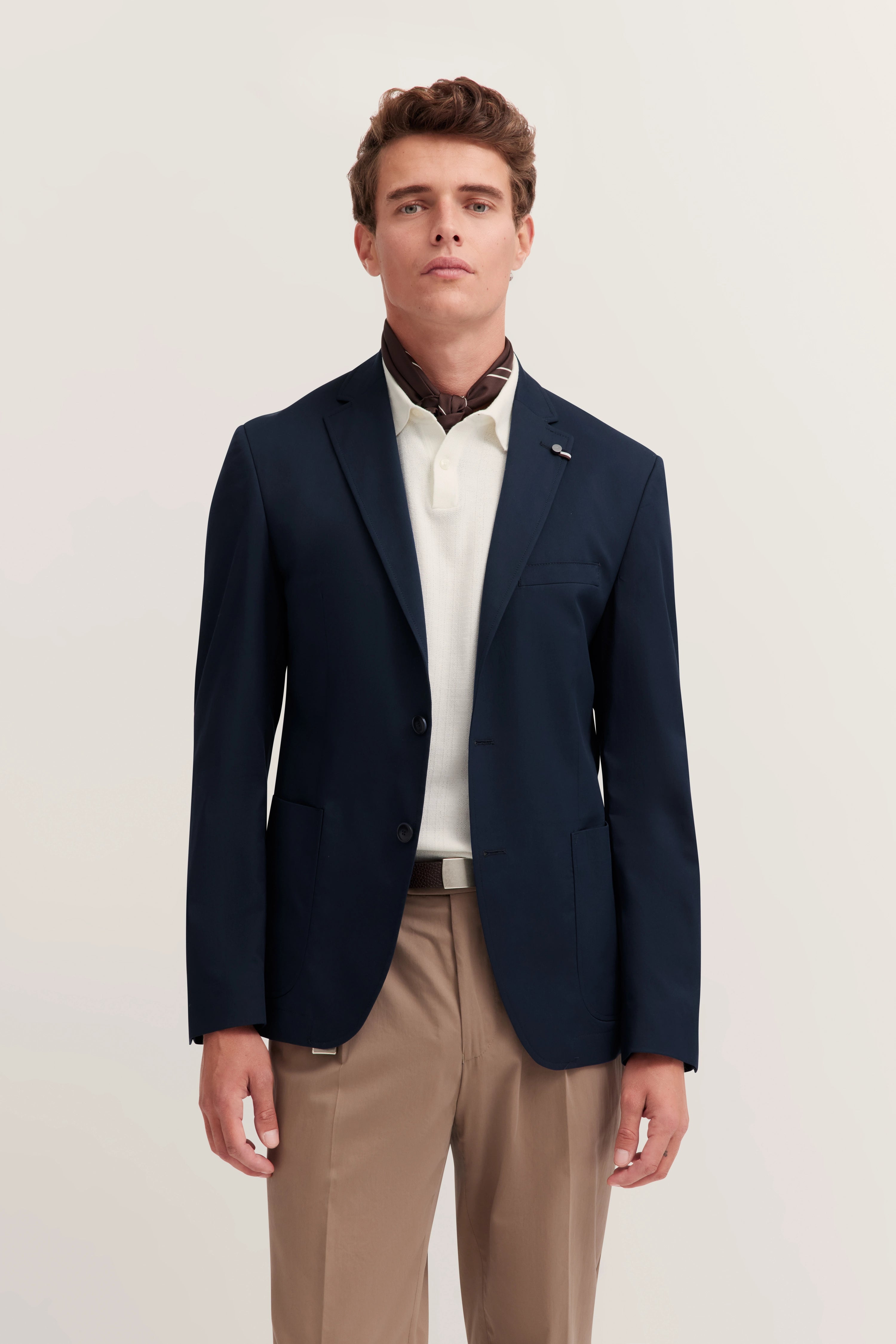 Model in dark blue bugatti blazer, white shirt, brown trousers