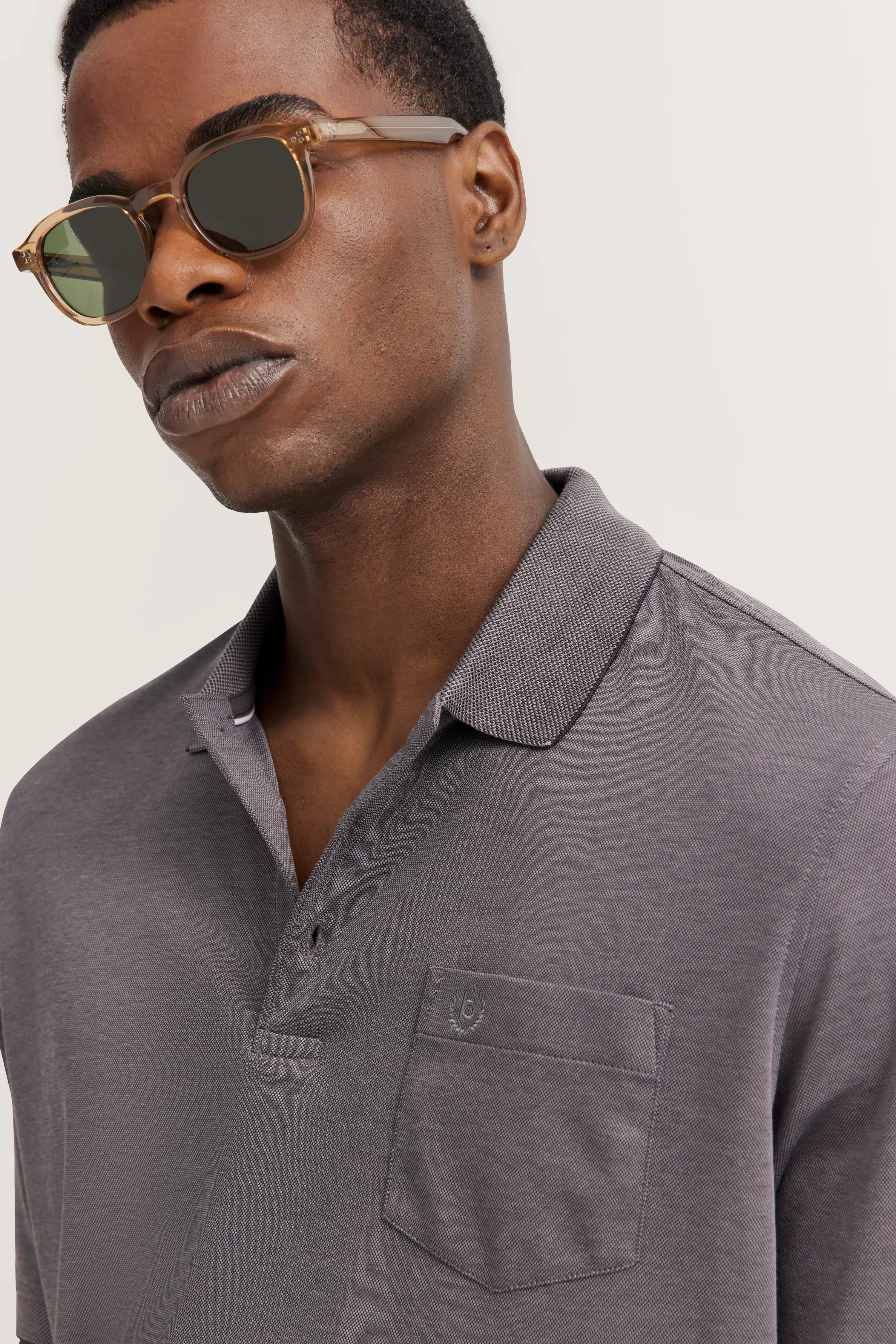Gray bugatti polo shirt with chest pocket, casual model with relaxed expression.