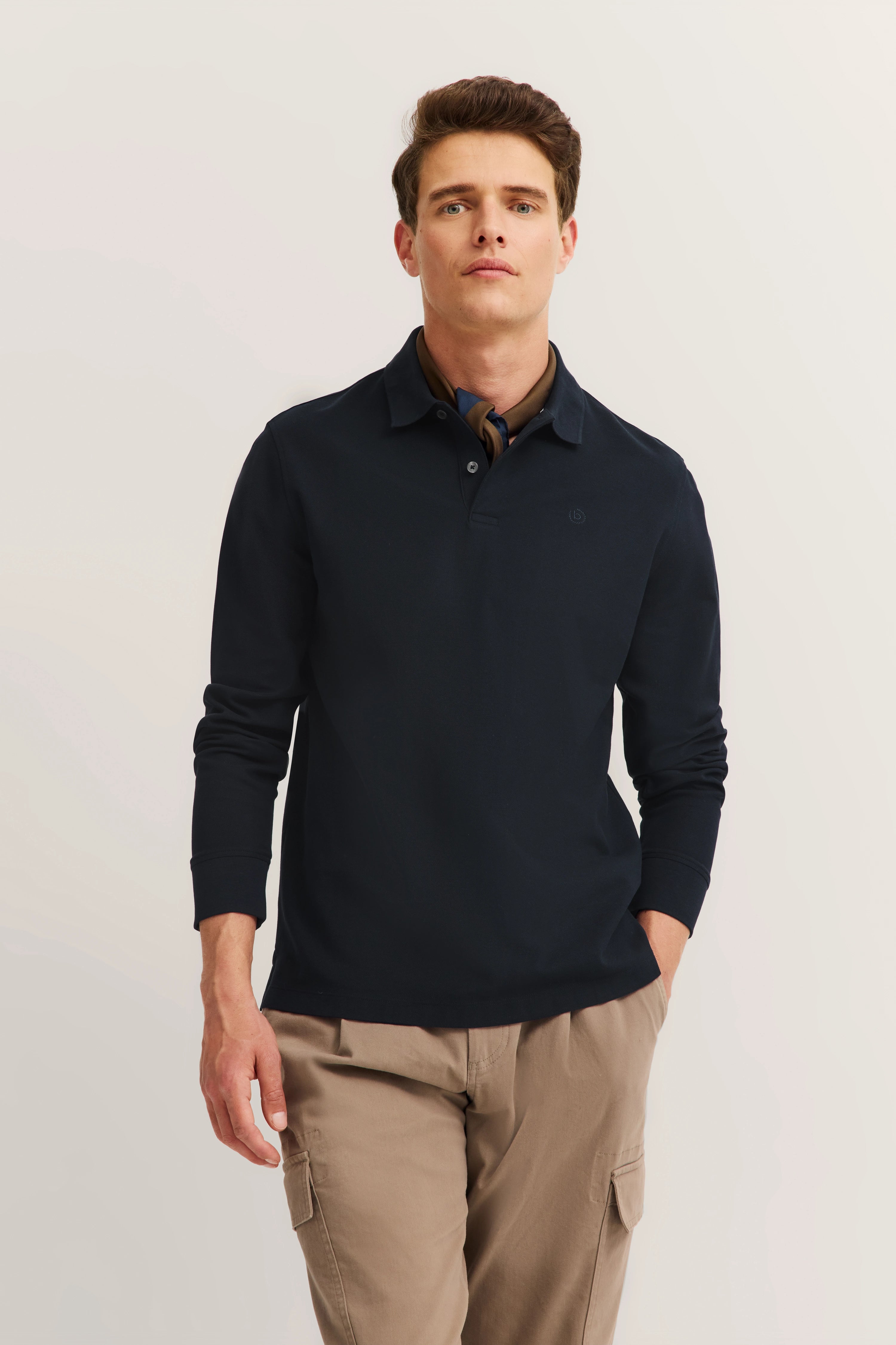 Model in navy bugatti sweater, beige cargo pants, casual pose.