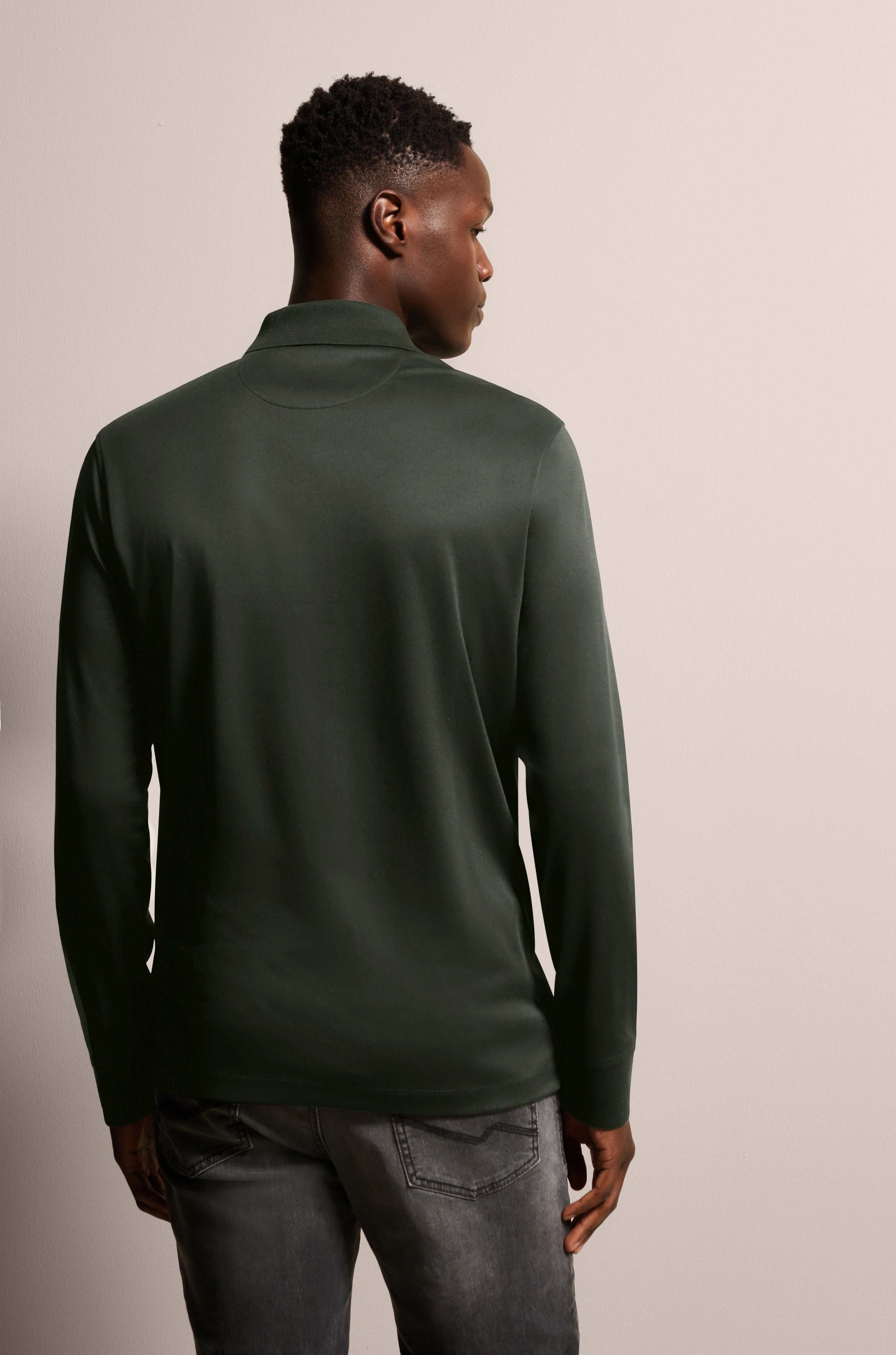 Dark green long-sleeve shirt by bugatti, casually worn from the back, paired with gray jeans.