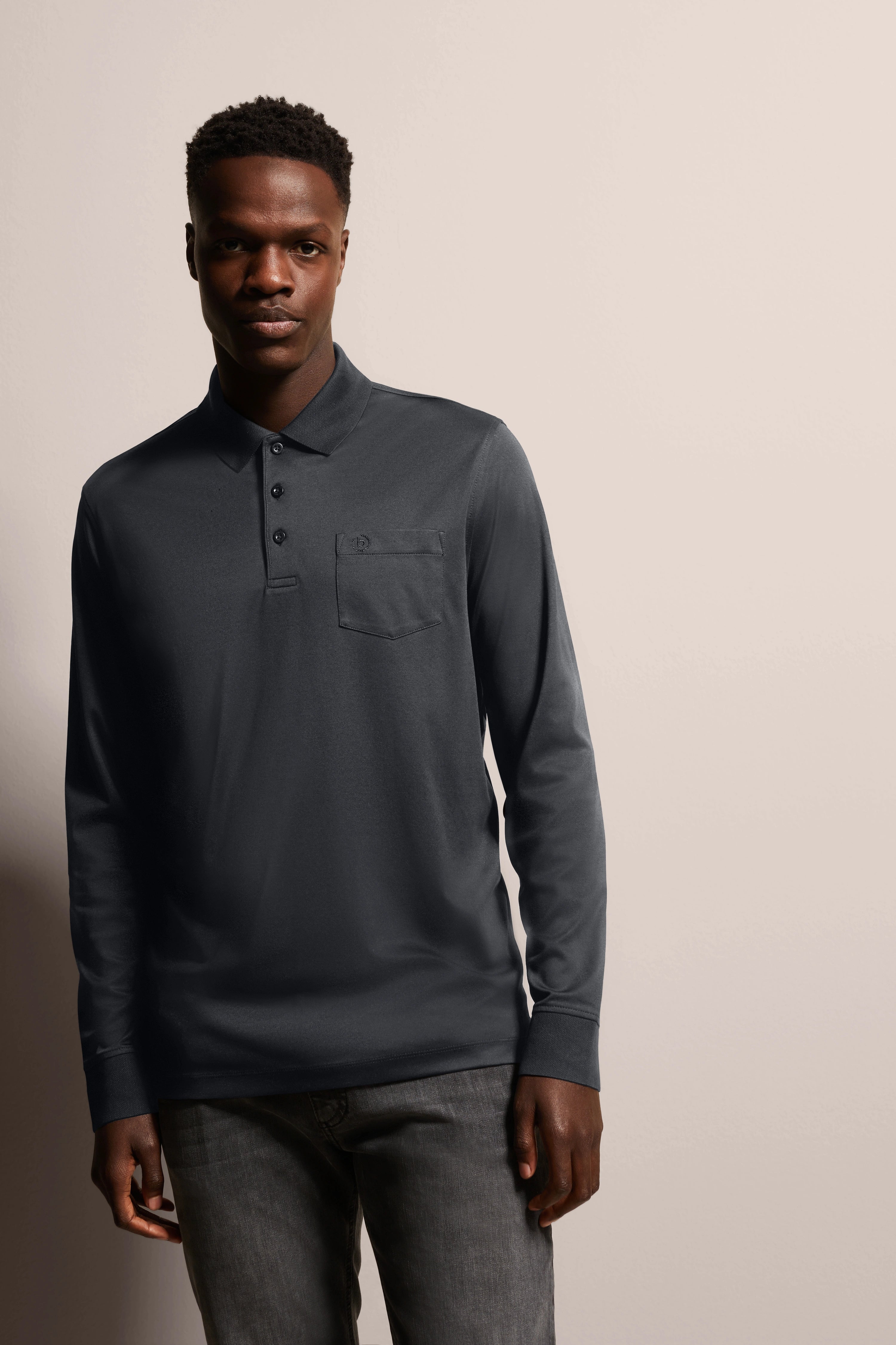 Dark grey long-sleeve polo by bugatti, casual model pose, relaxed elegance and timeless style.