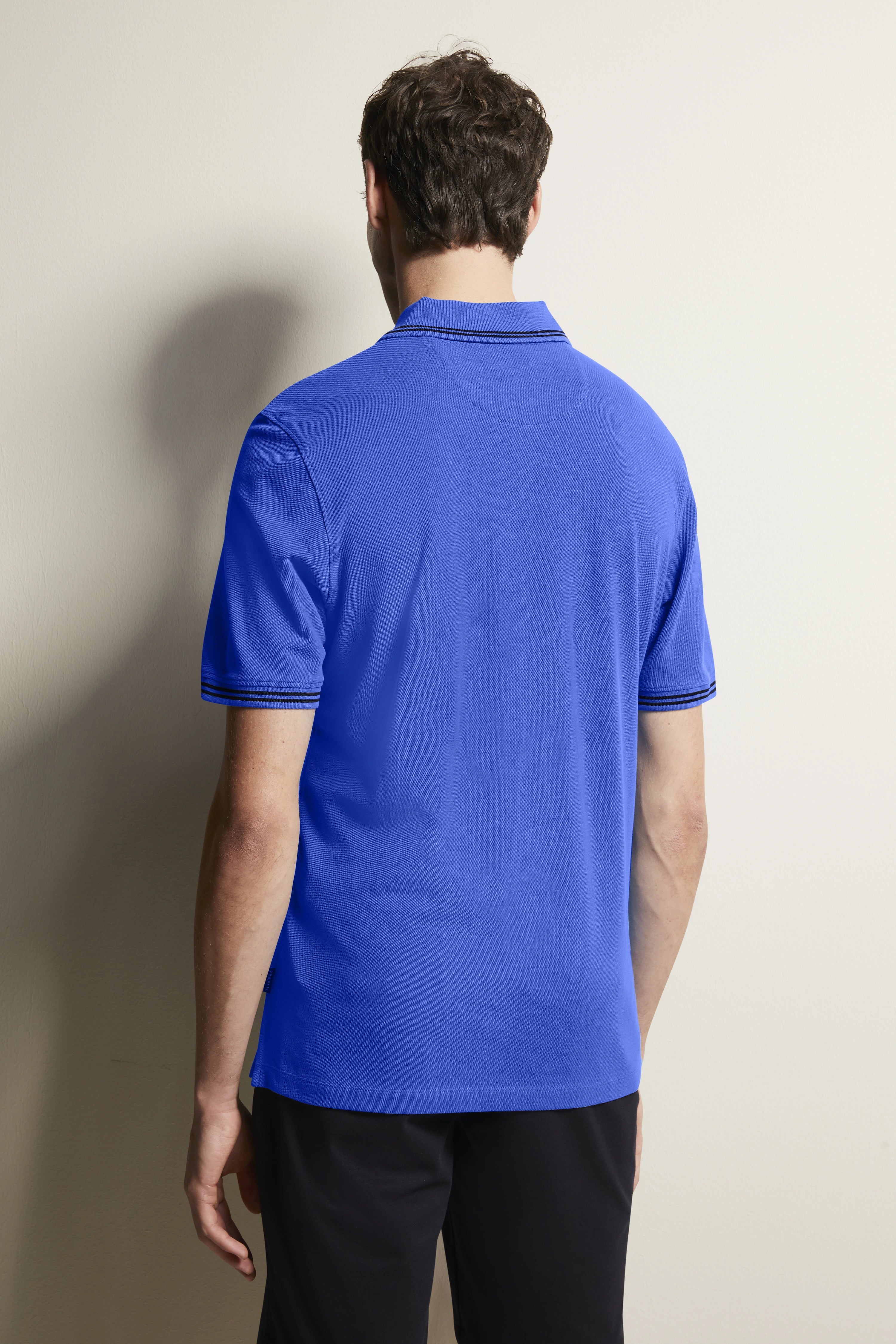 bugatti blue polo shirt, back view, casual model, relaxed pose.