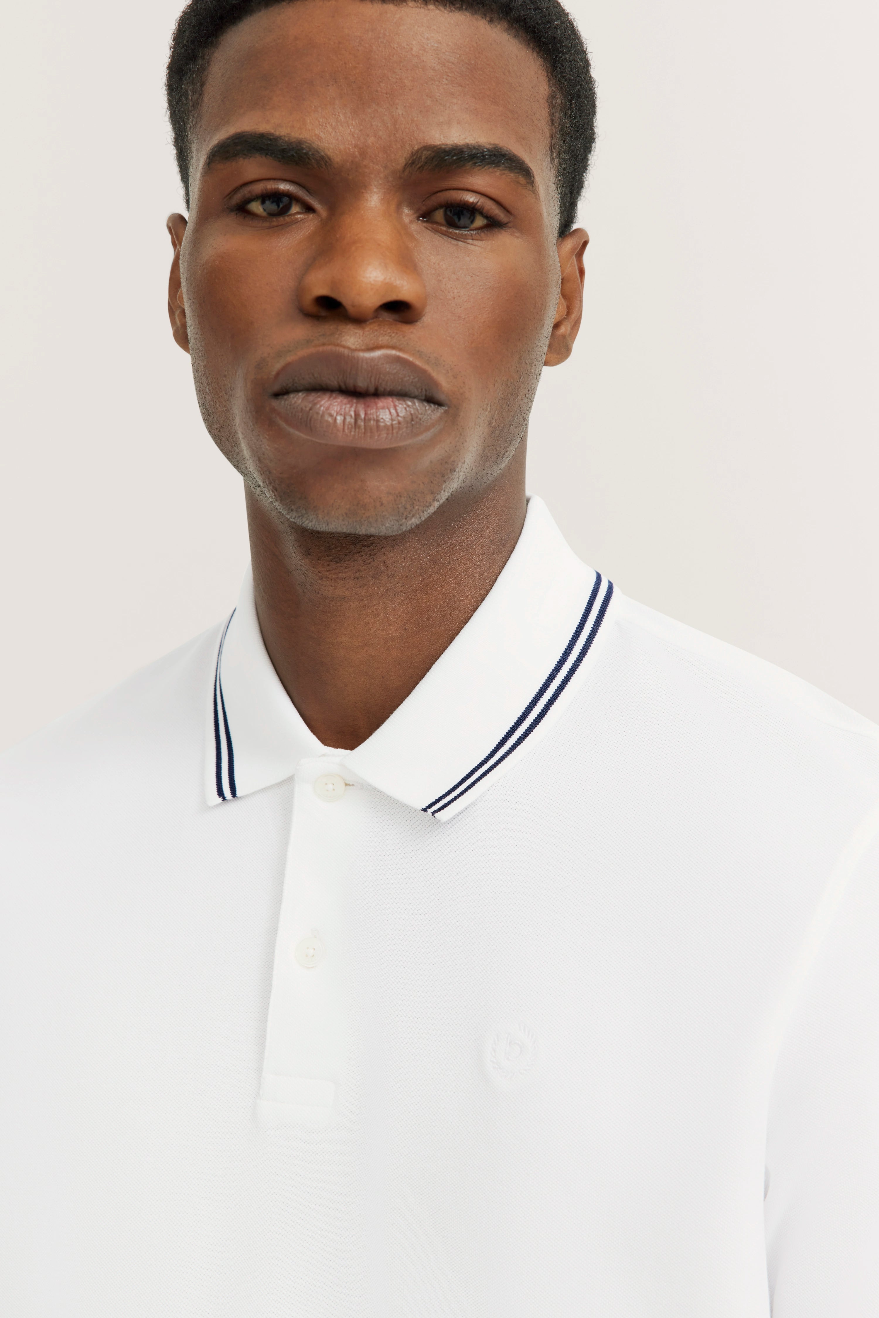 White bugatti polo shirt bust with striped collar, minimalist design.