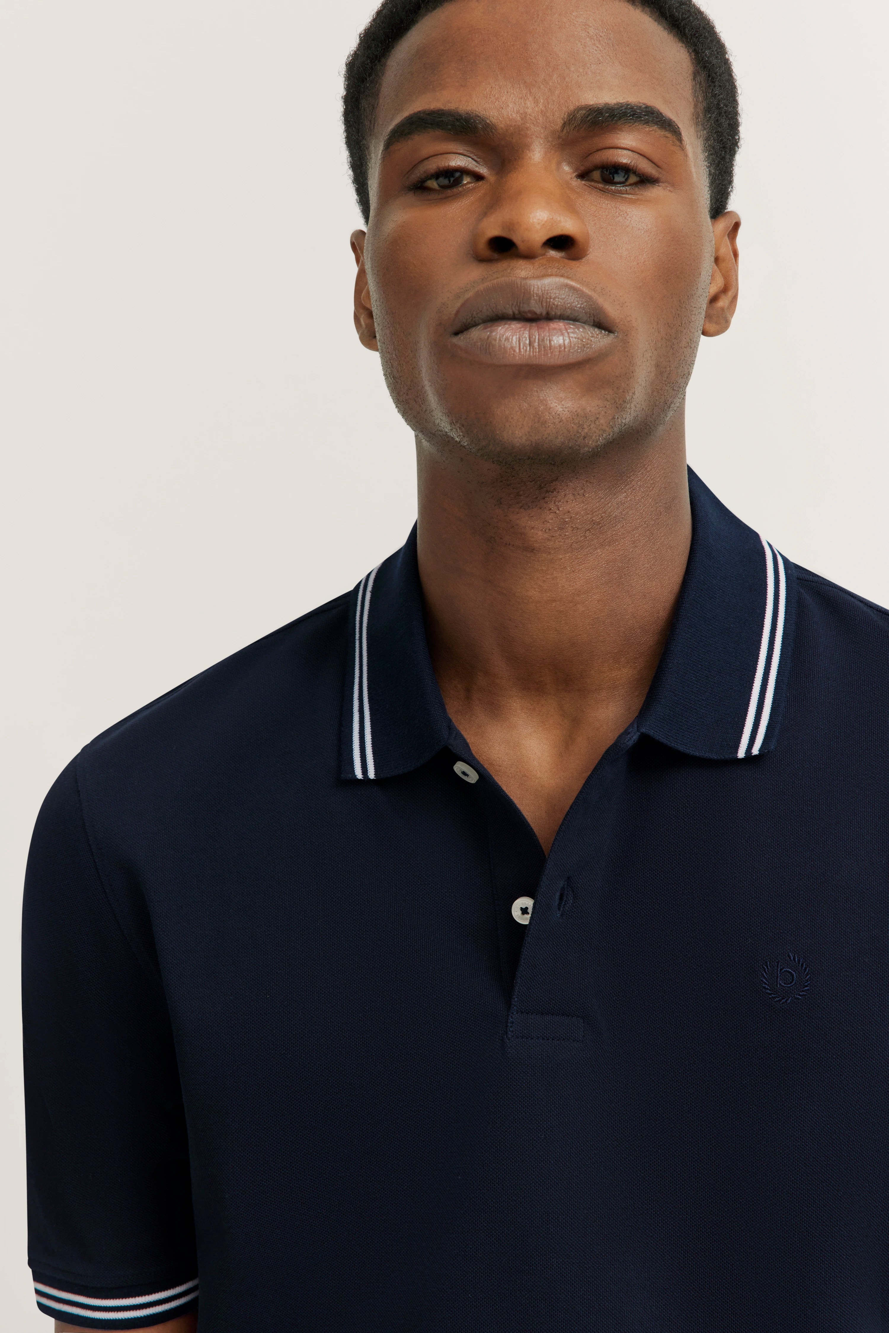 bugatti Navy Polo Shirt, model pose, casual style, white collar stripe.