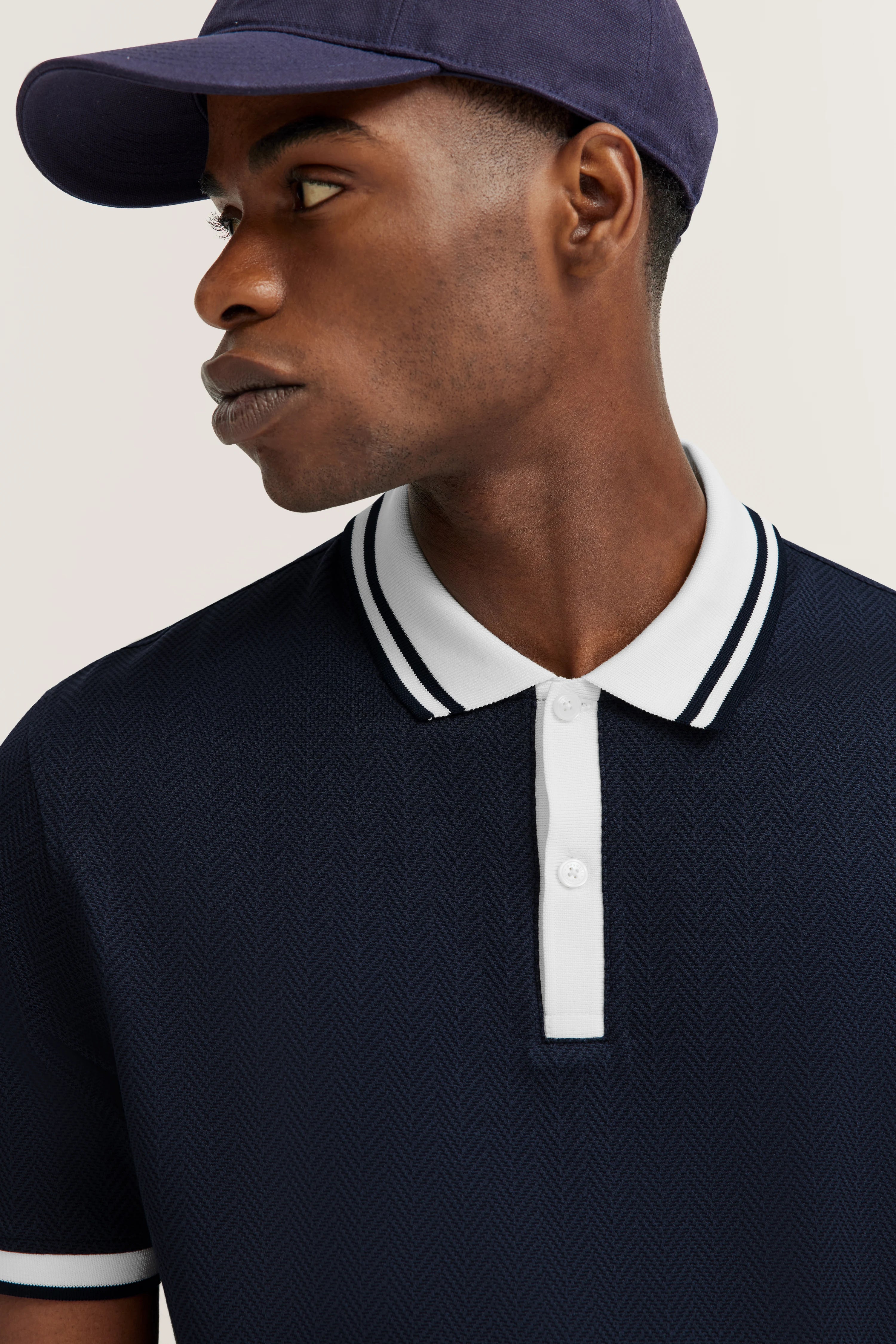 Dark blue bugatti polo shirt with chevron pattern, bust image, white collar and cuffs.