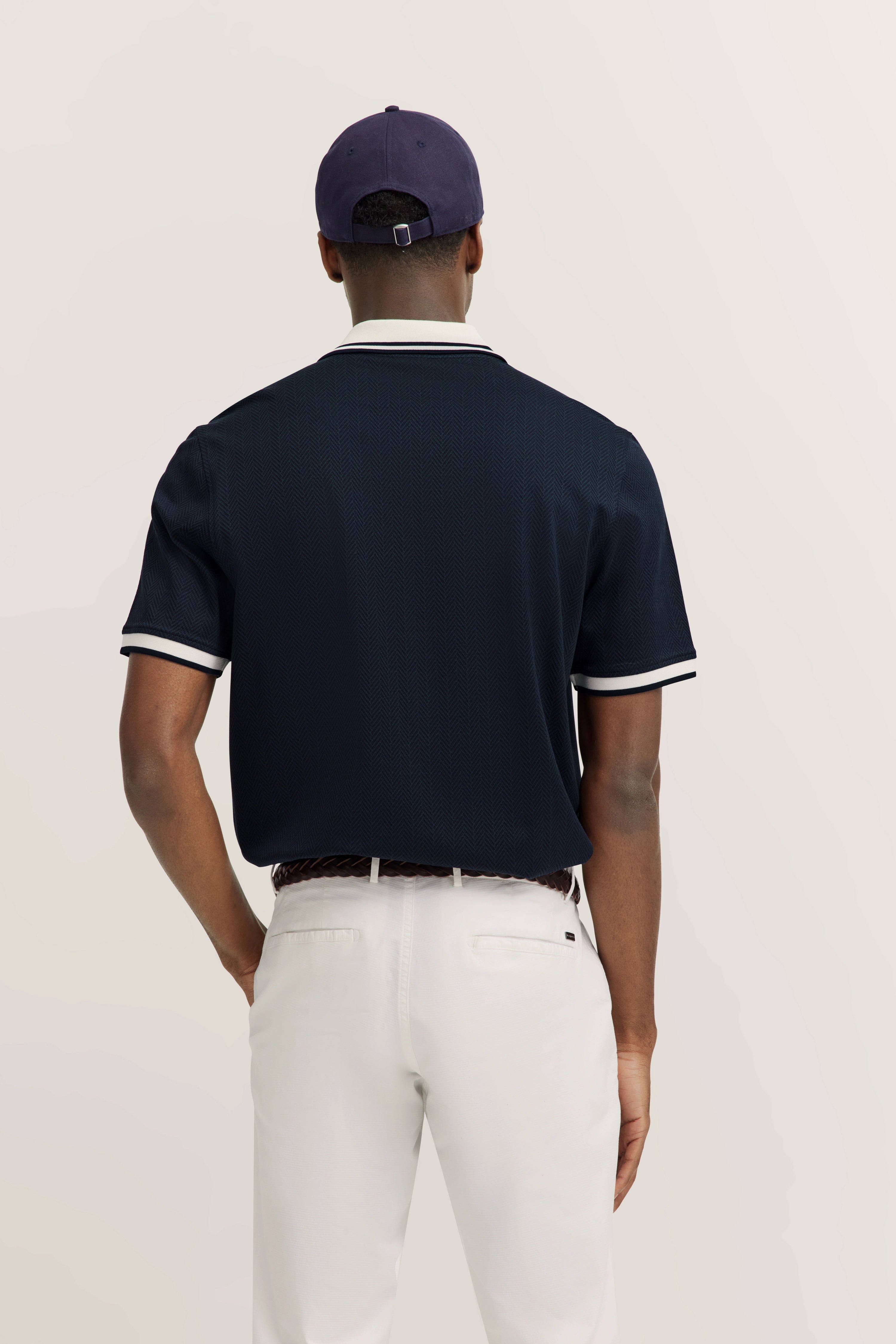 bugatti model in navy polo shirt, white trousers