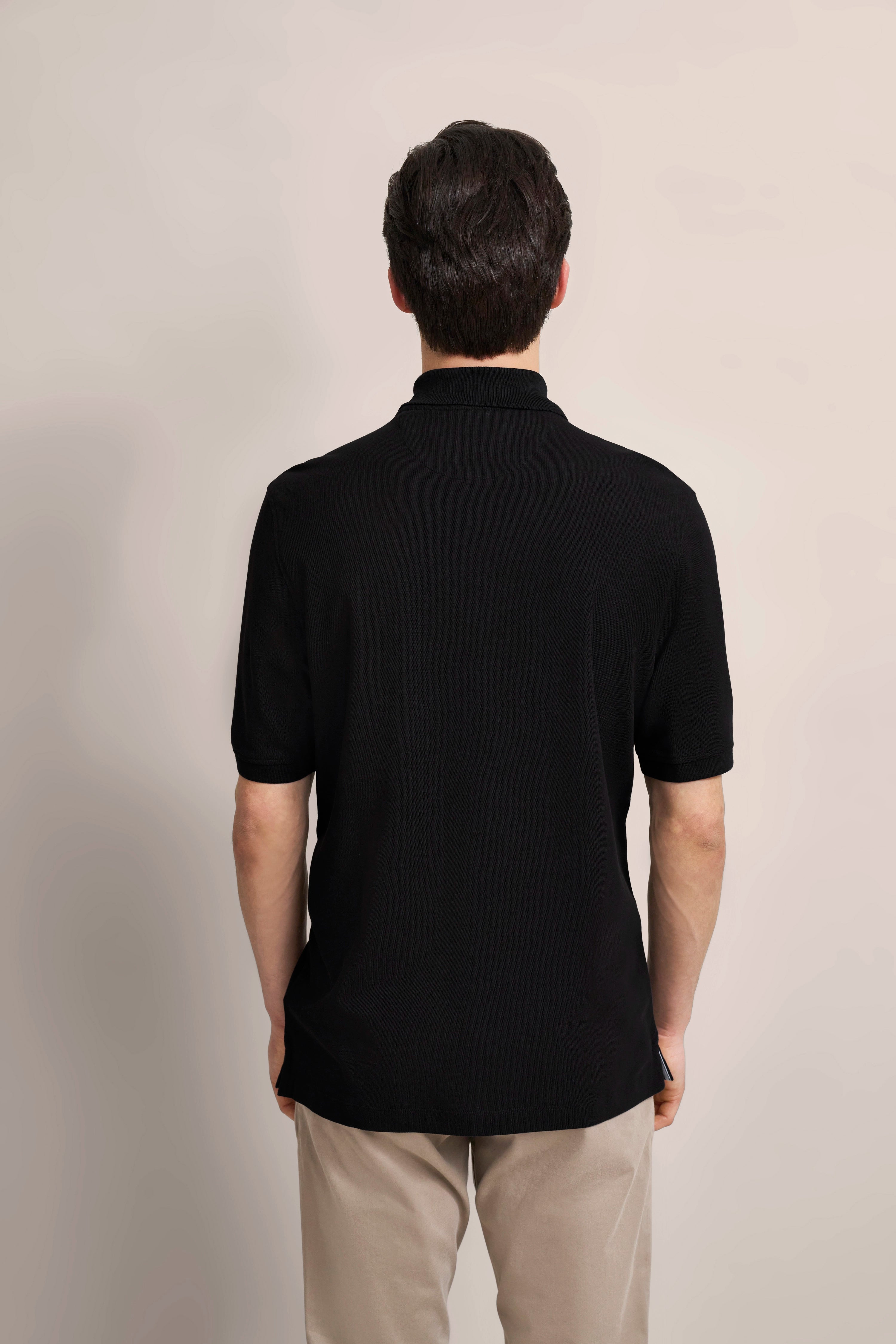 bugatti model, man in black polo shirt, beige pants, back view, relaxed pose.