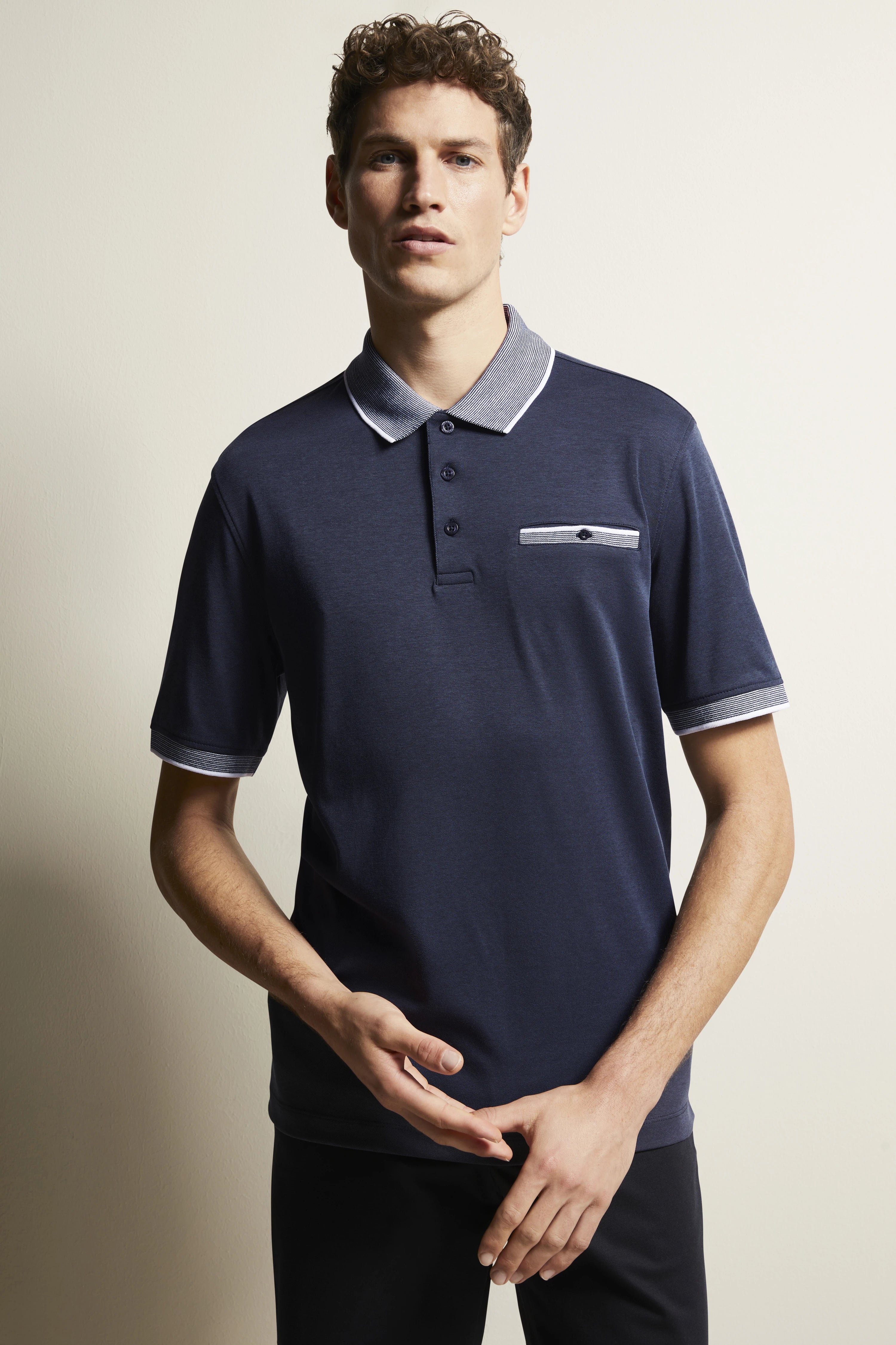 Dark blue bugatti polo shirt with grey collar, chest pocket, and casual model pose.