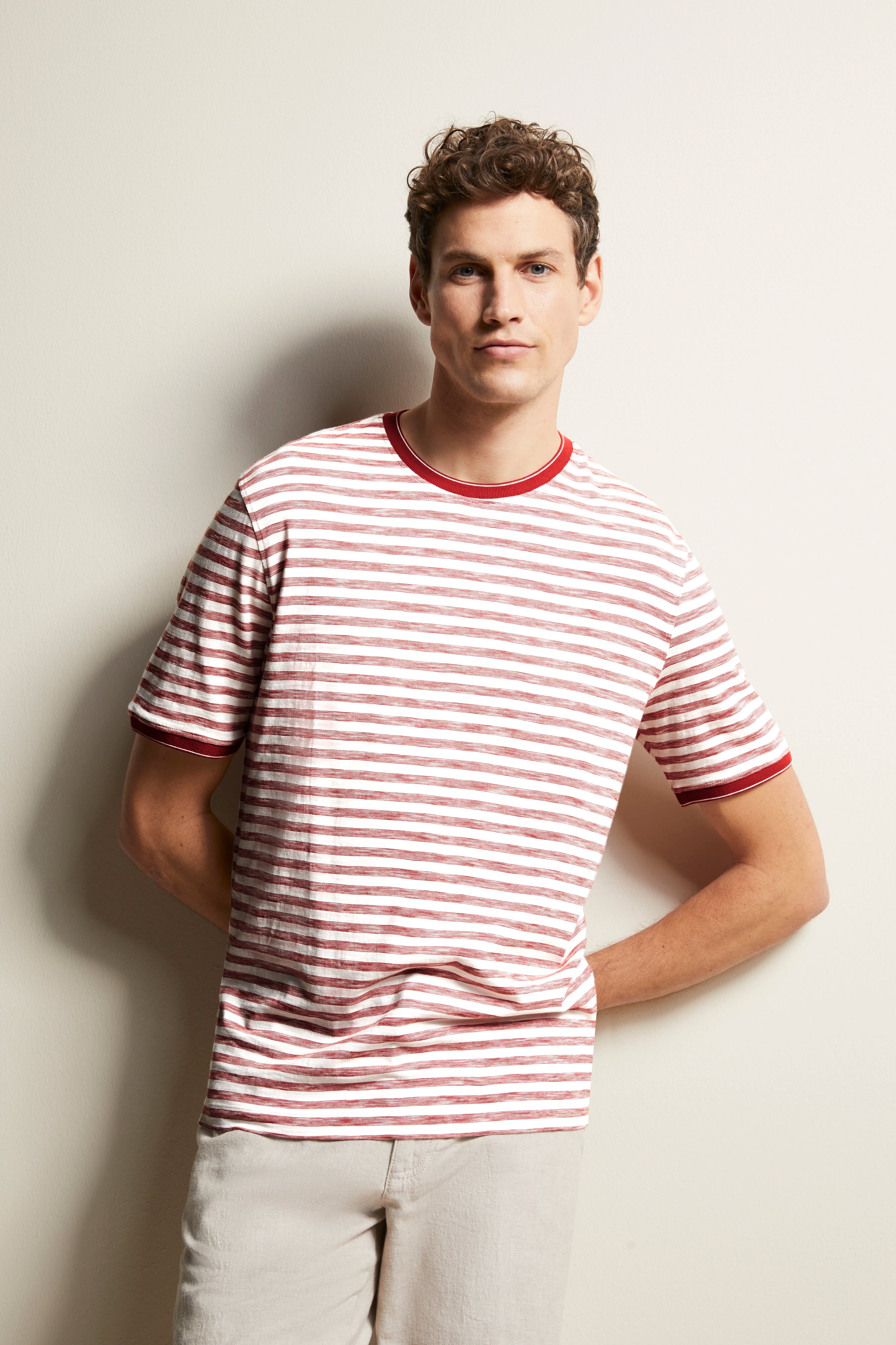 Red-white striped shirt, casually worn by model, hands in pockets, bugatti style.