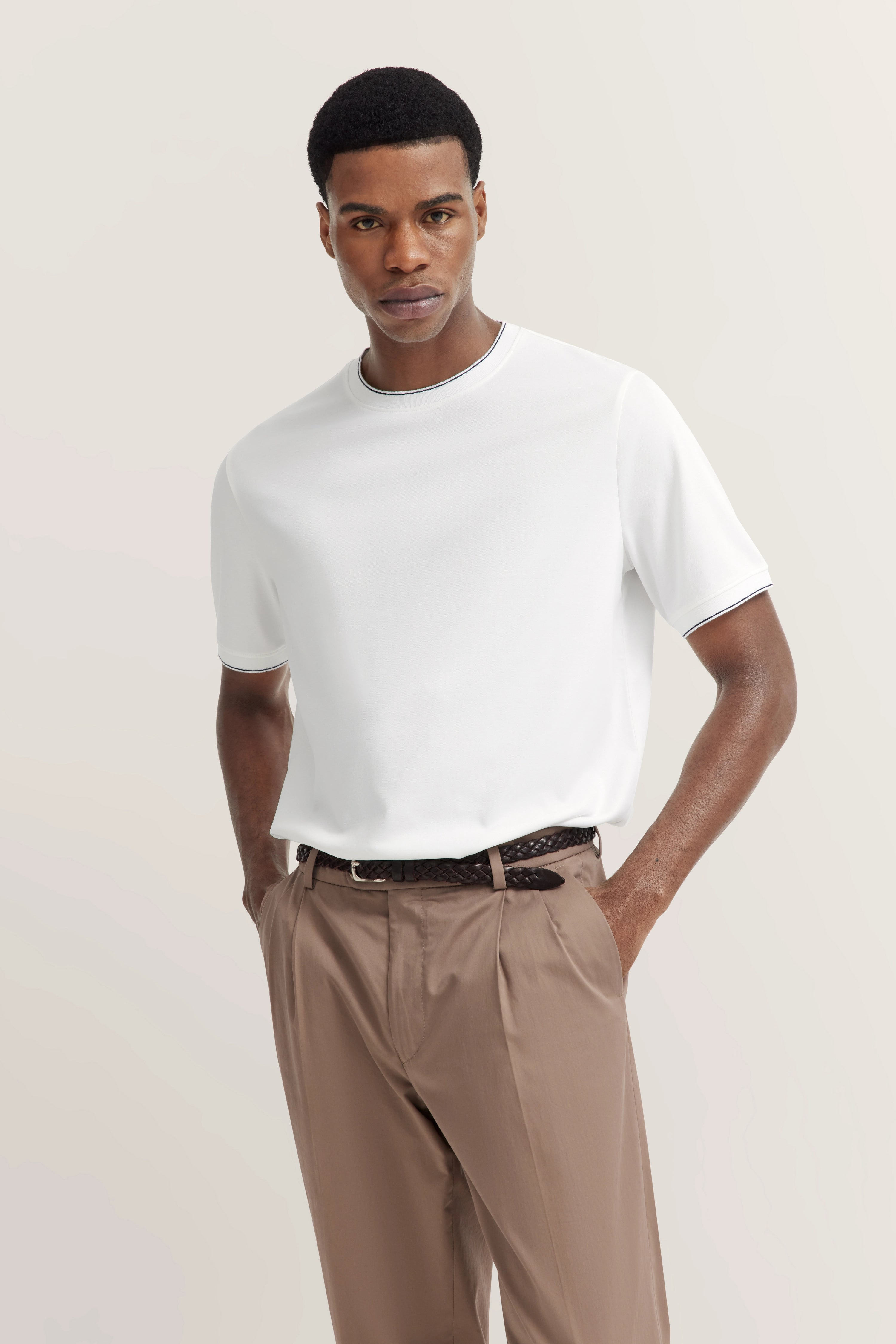 White T-shirt and beige pants, casual model pose, relaxed vibe, bugatti.