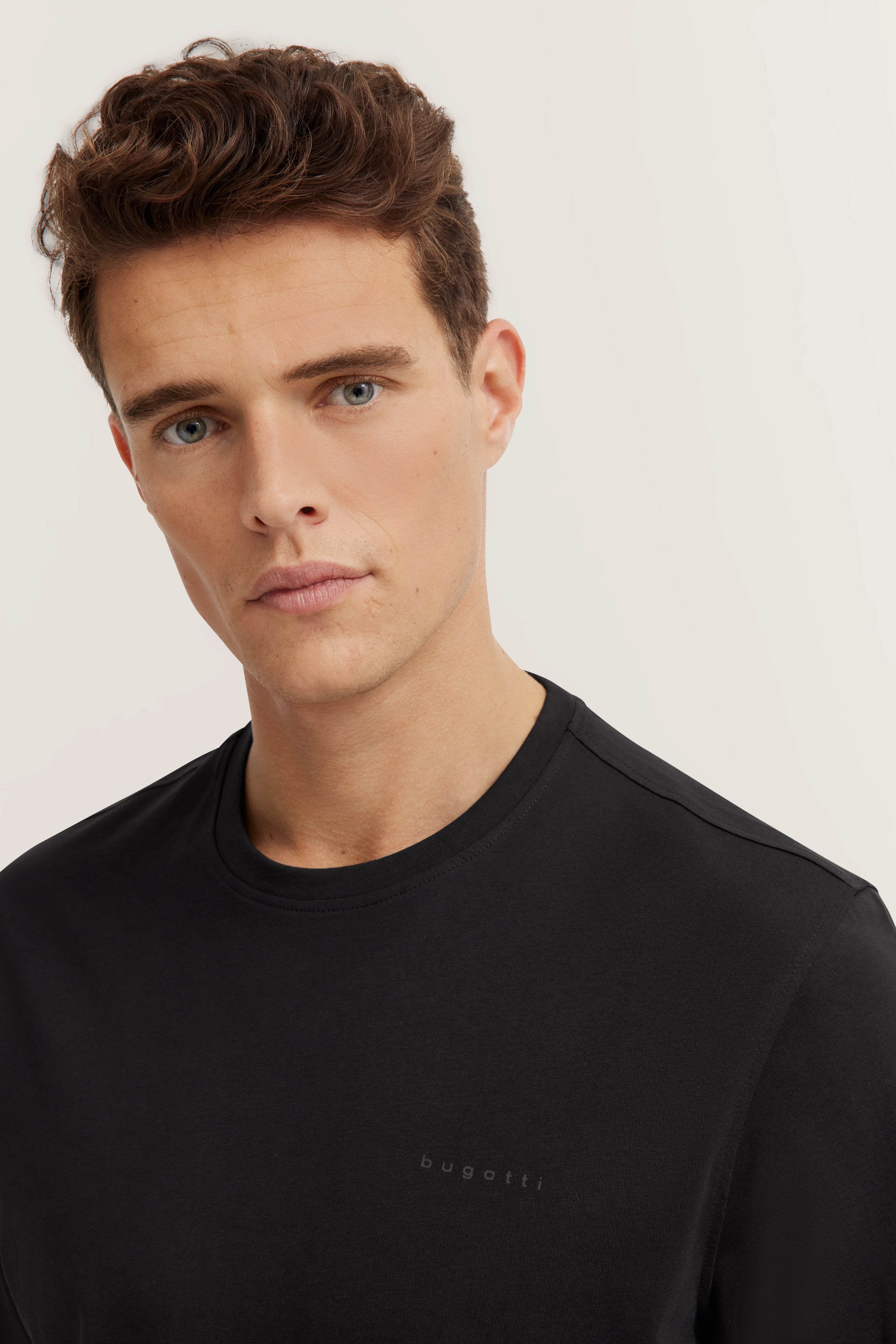 Black bugatti T-shirt, model image, relaxed pose, elegant look, timeless sophistication.